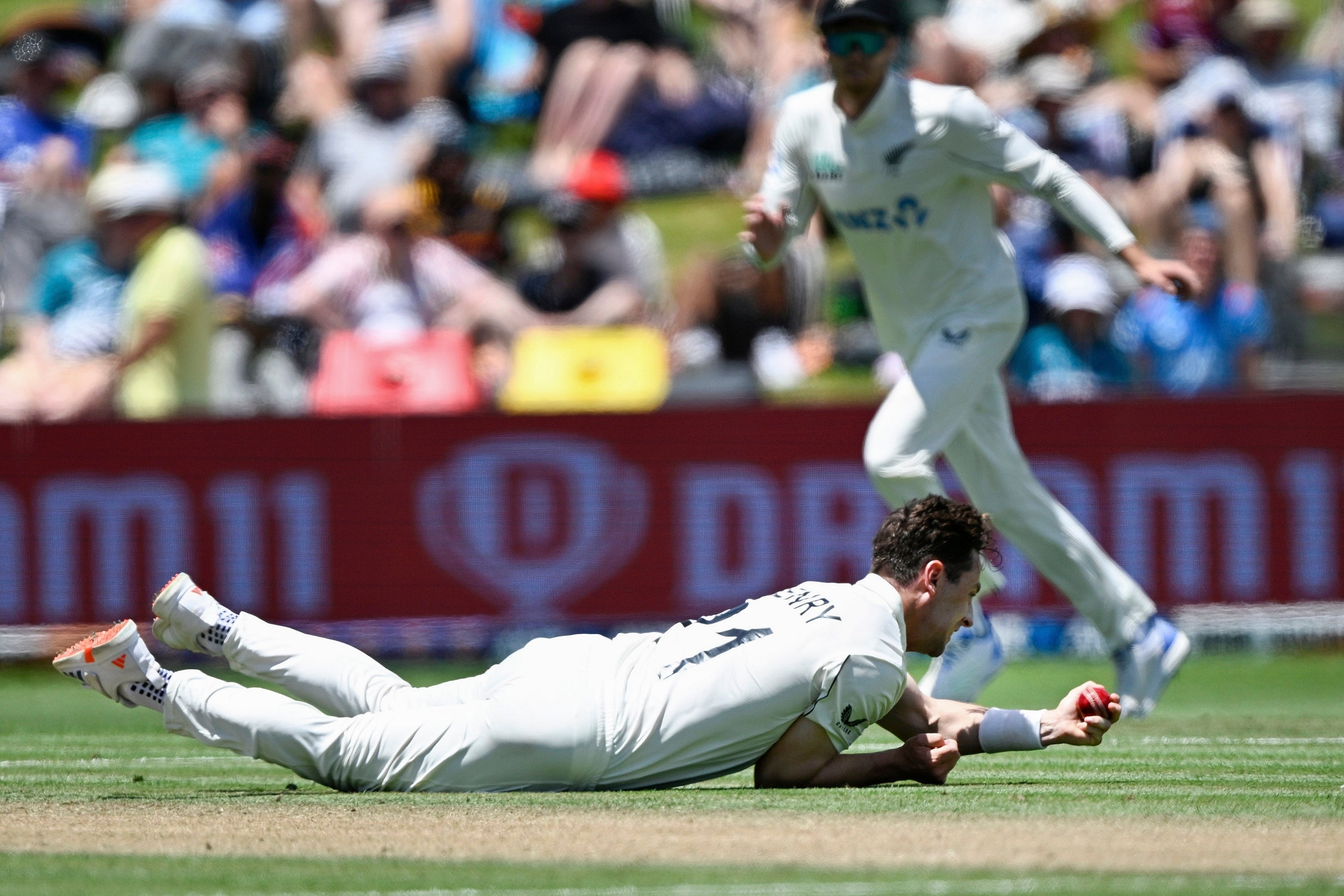 Matt Henry takes a catch off his own bowling to dismiss Zak Crawley (Andrew Cornaga/Photosport/AP)