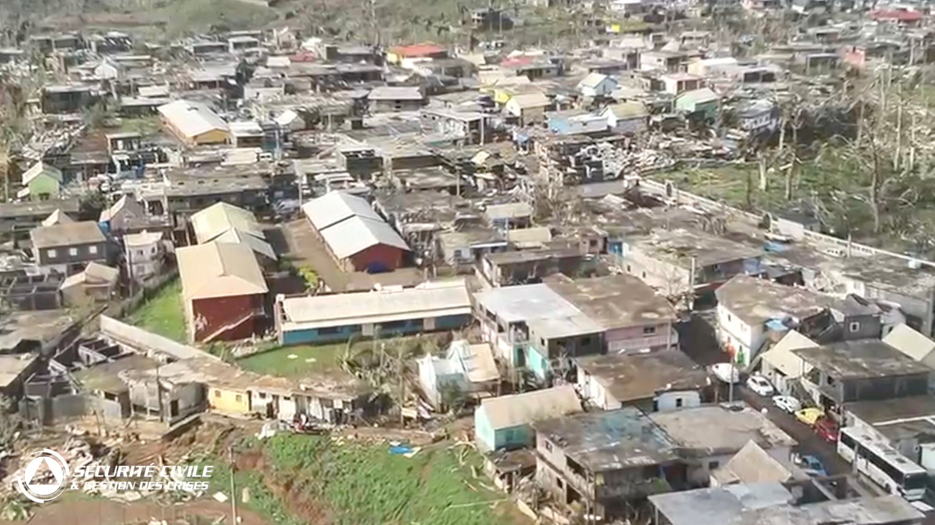 Damaged houses remain and debris lies on the ground after Cyclone Chido swept through Mayotte