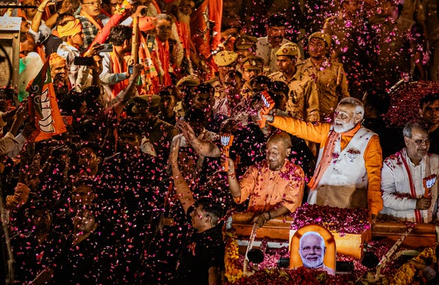 <p>Indian prime minister Narendra Modi waves to supporters during his roadshow in India's Hindu heartland</p>