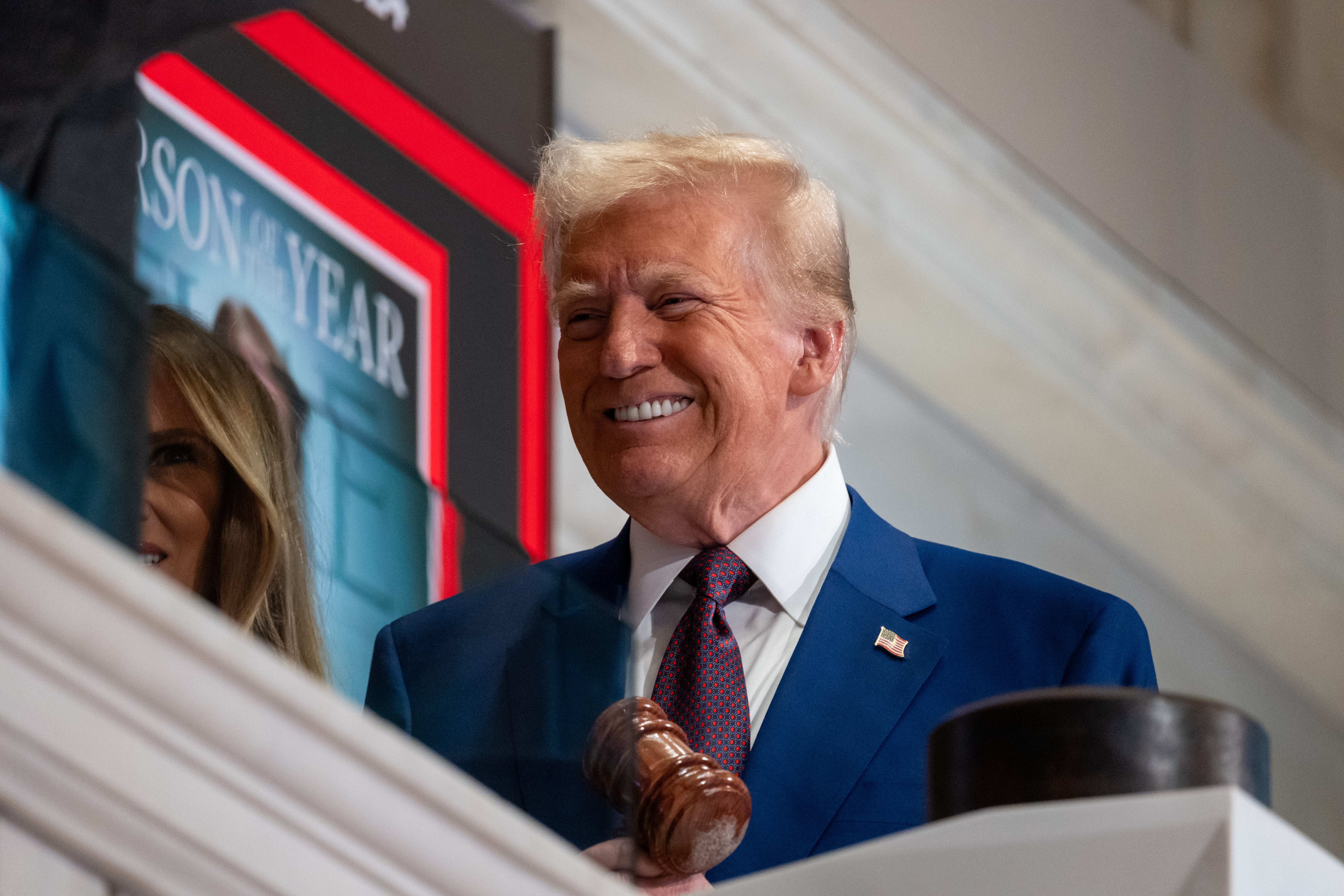 President-elect Donald Trump rings the opening bell on the trading floor of the New York Stock Exchange on December 12. A new report highlights the number of foreign-born workers his companies have hired