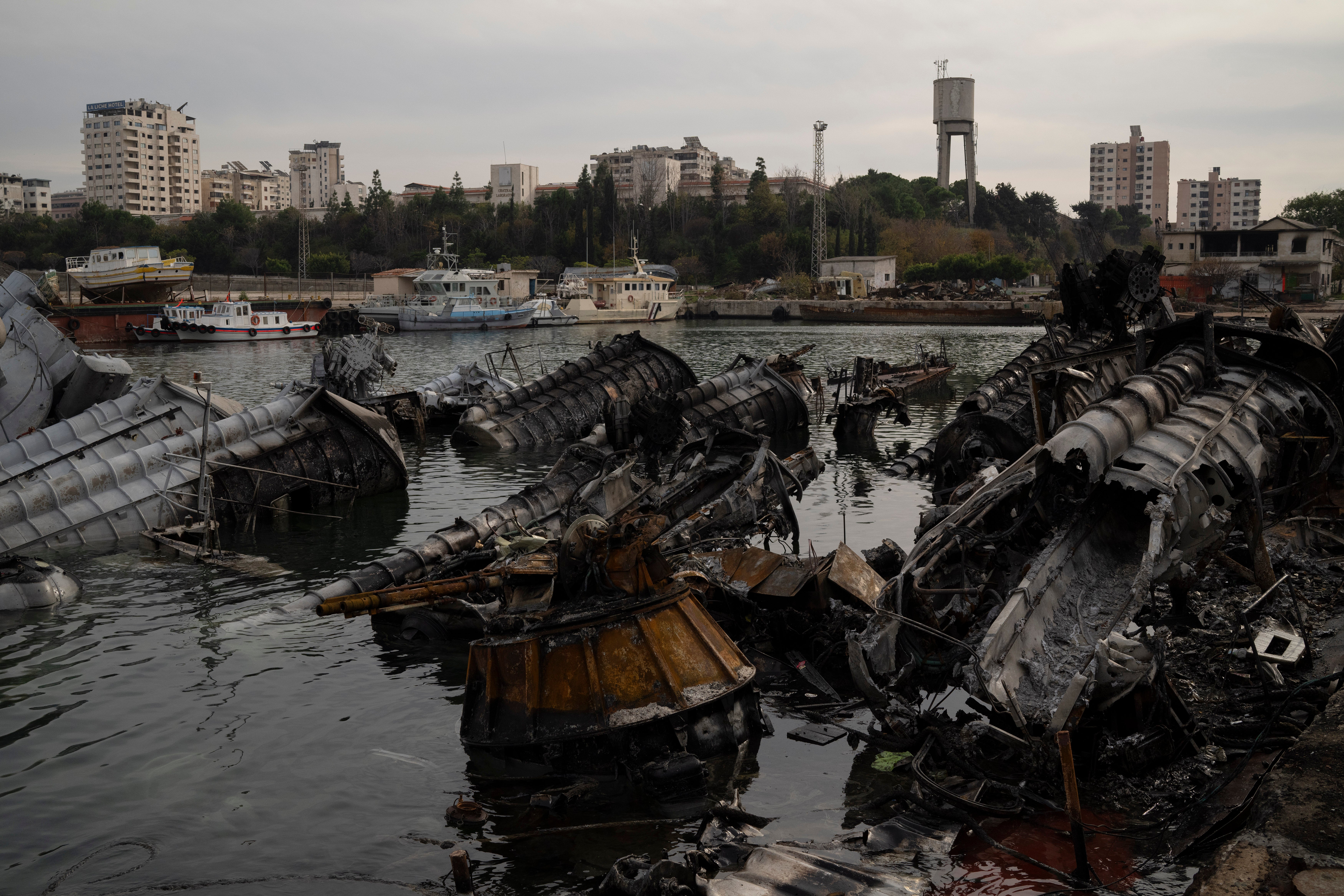 <p>Destroyed Syrian naval vessels are seen in the port of Latakia on Monday </p>