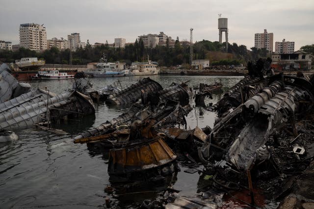 <p>Destroyed Syrian naval vessels are seen in the port of Latakia on Monday </p>