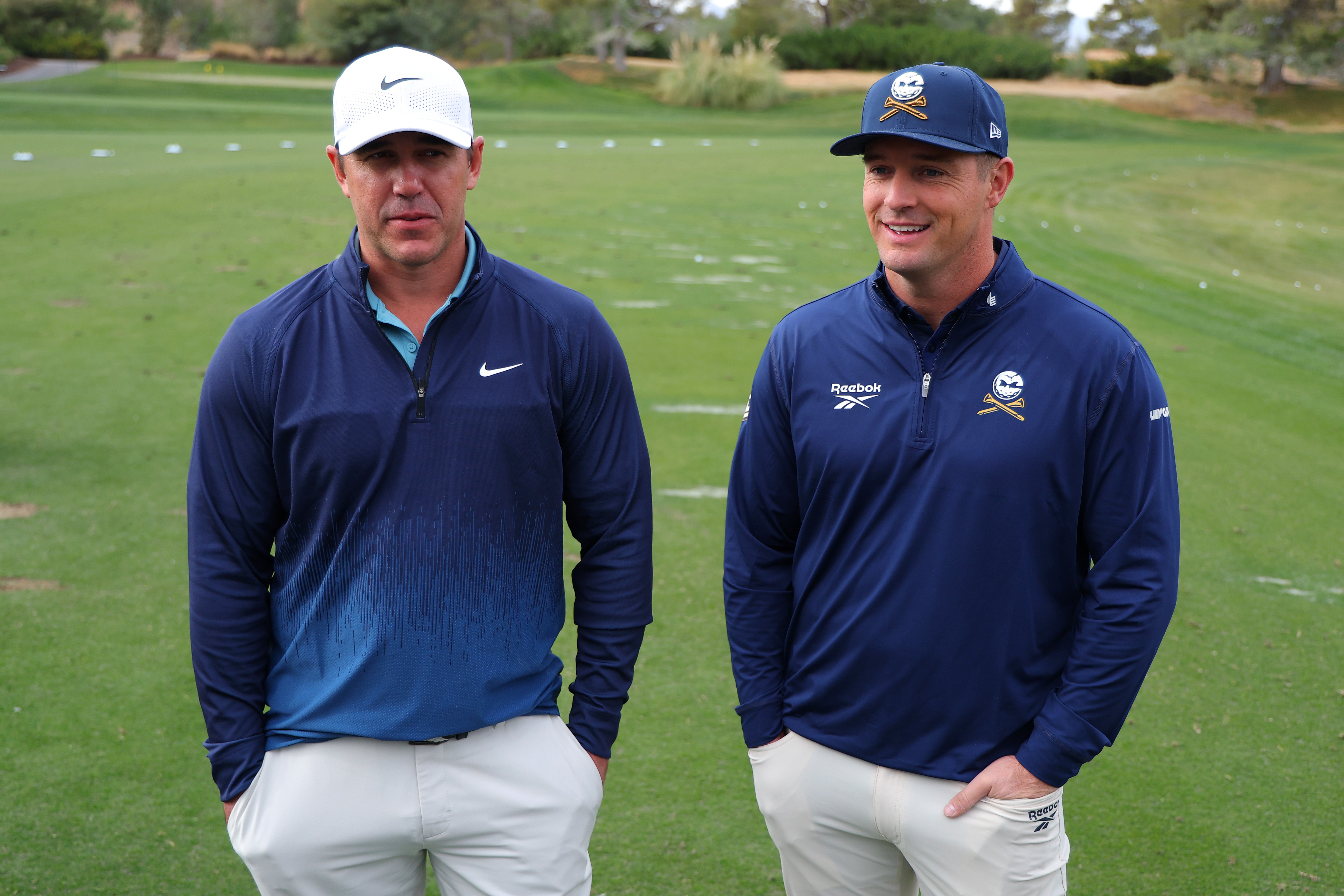 Brooks Koepka and Bryson DeChambeau of LIV Golf look on before The Showdown