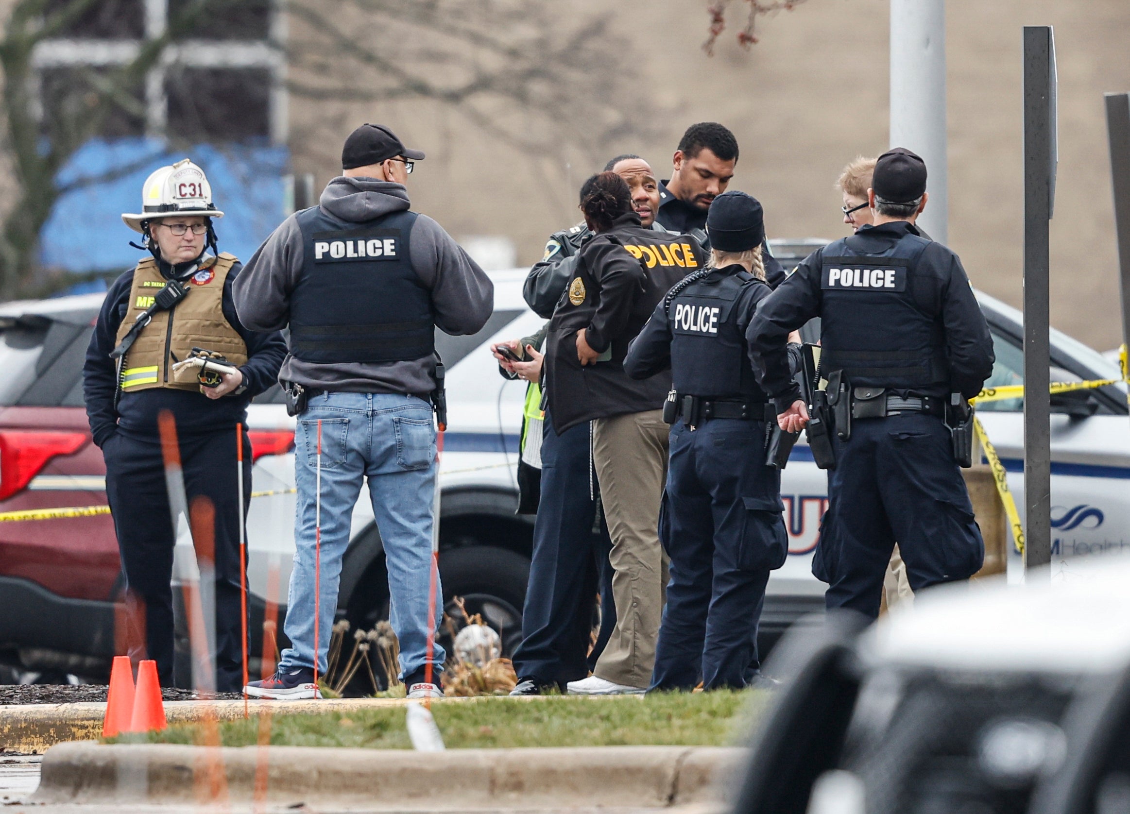 Police gather at a reunification center after a shooting at Abundant Life Christian School in Madison