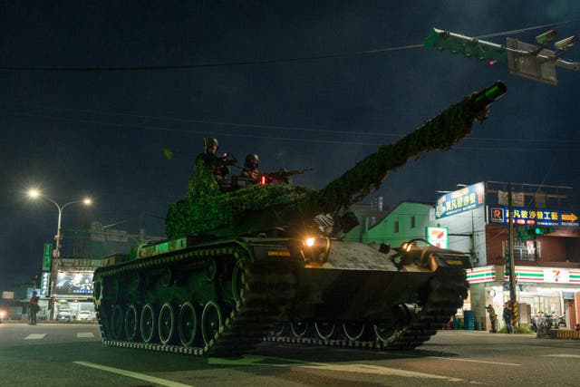 <p>File: A main battle tank drives through the streets of Taoyuan as part of an exercise</p>