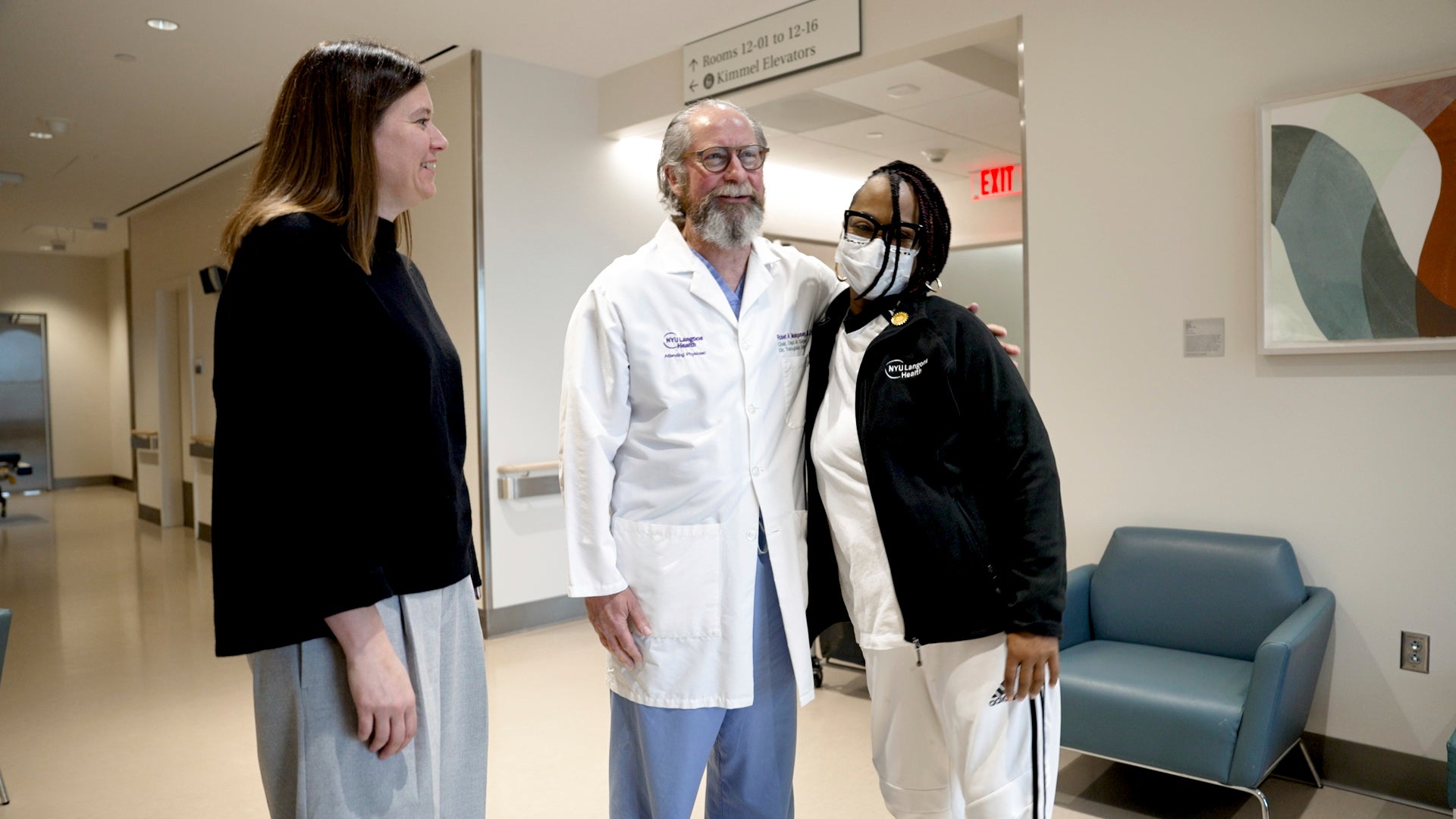 Pig kidney recipient Towana Looney stands with transplant surgeons Dr. Jayme Locke, left, and Dr. Robert Montgomery of New York City’s NYU Langone Health. Looney is recovering well