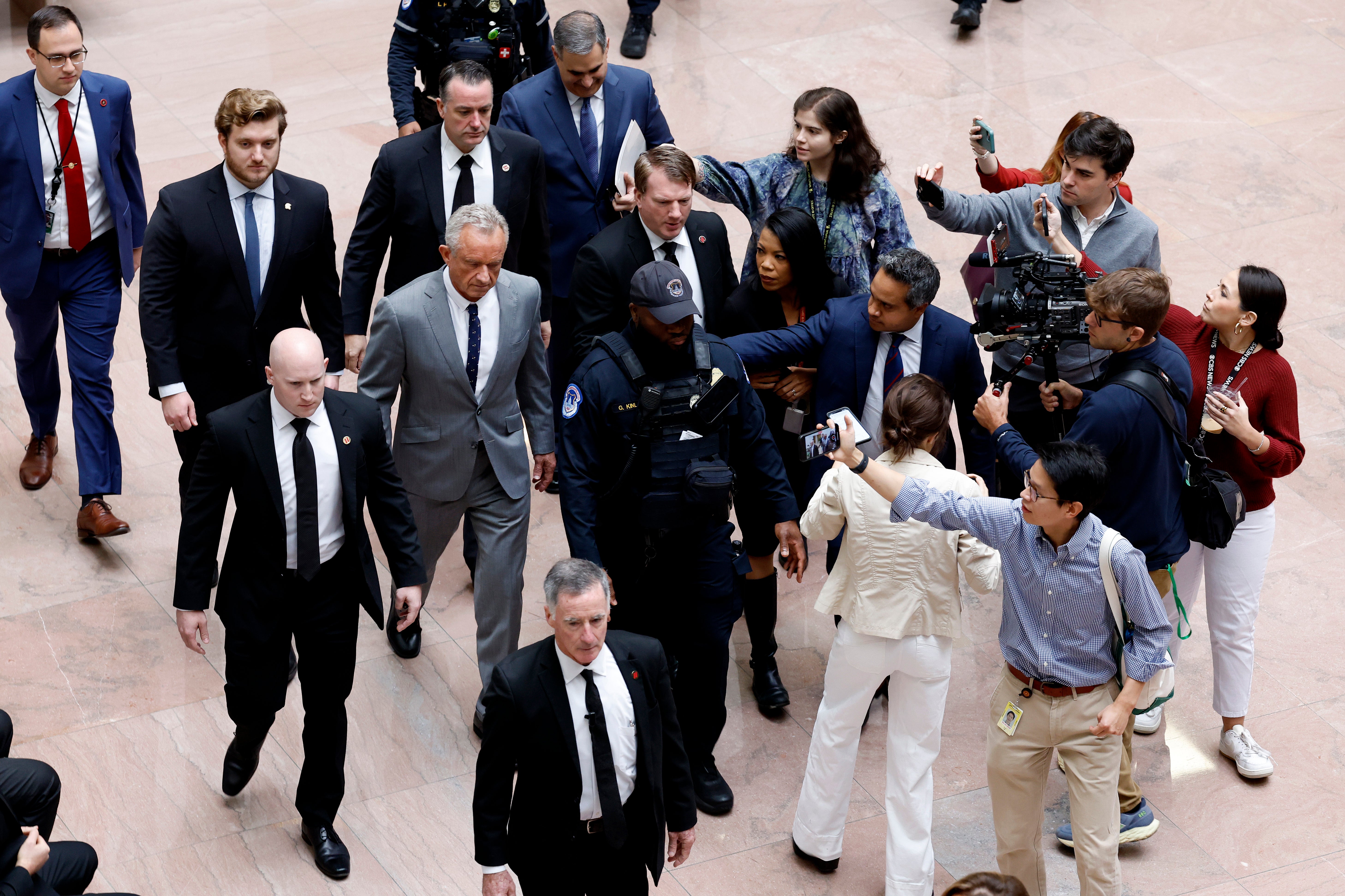 Reporters follow Robert F. Kennedy Jr., President-elect Donald Trump’s nominee to be Secretary of Health and Human Services, as he arrives for a meeting with Sen. Steve Daines (R-MT) in the Hart Senate Office Building on December 17, 2024 in Washington, DC