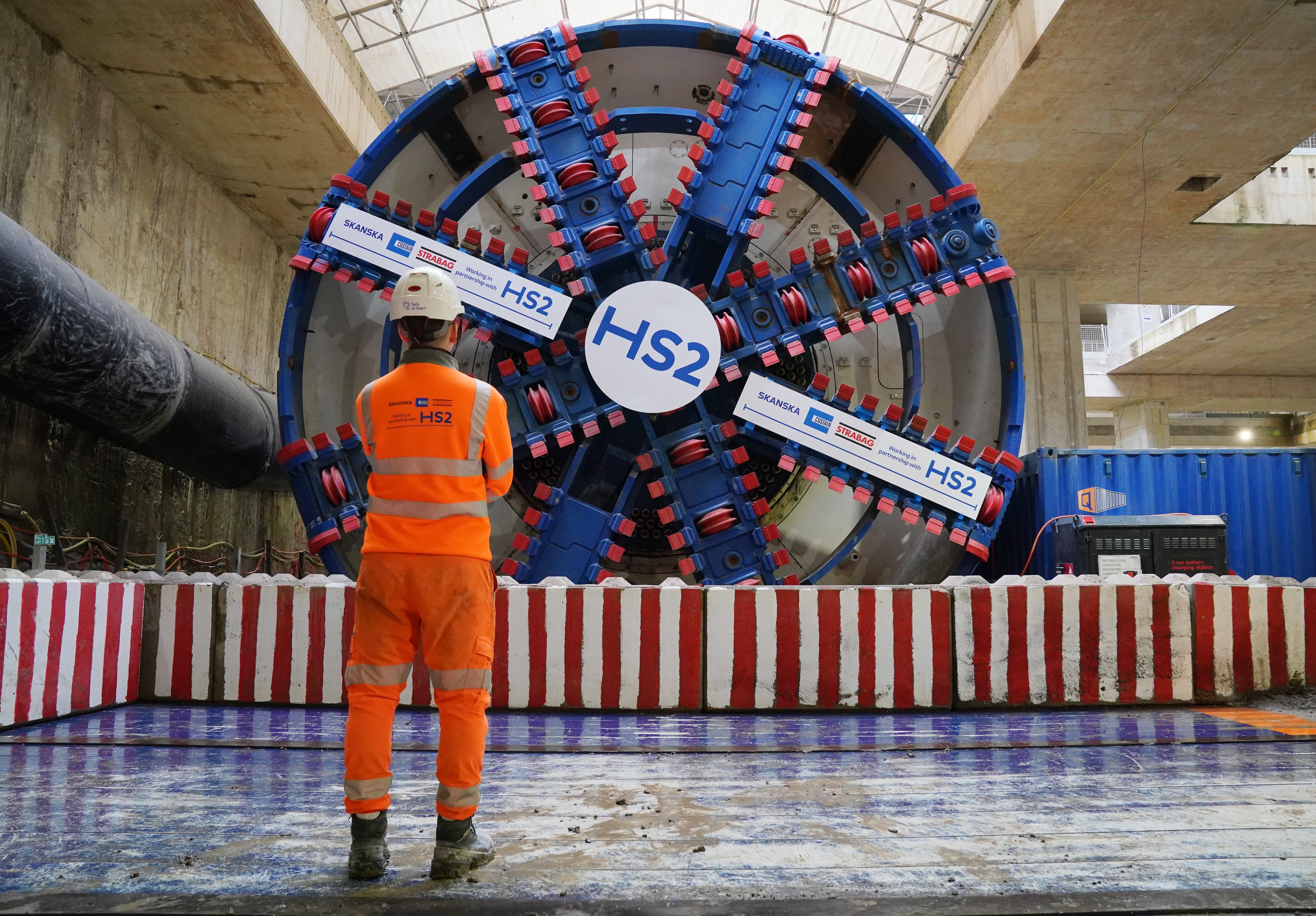 An HS2 worker stands in front of tunnel boring machine Karen at the Old Oak Common station box site (Jonathan Brady/PA)