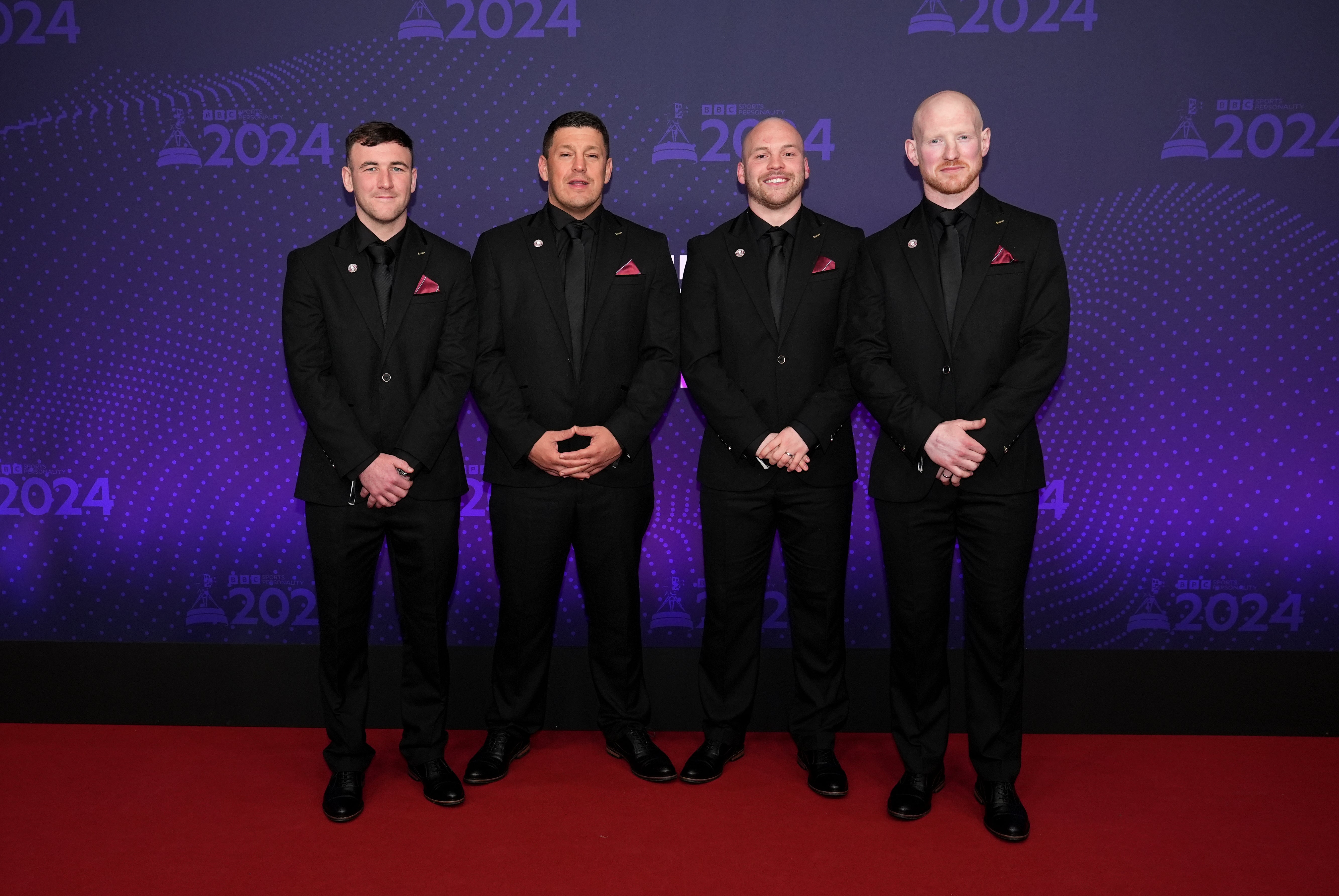 Wigan Warriors' Harry Smith, head coach Matt Peet, Liam Marshall and Liam Farrell