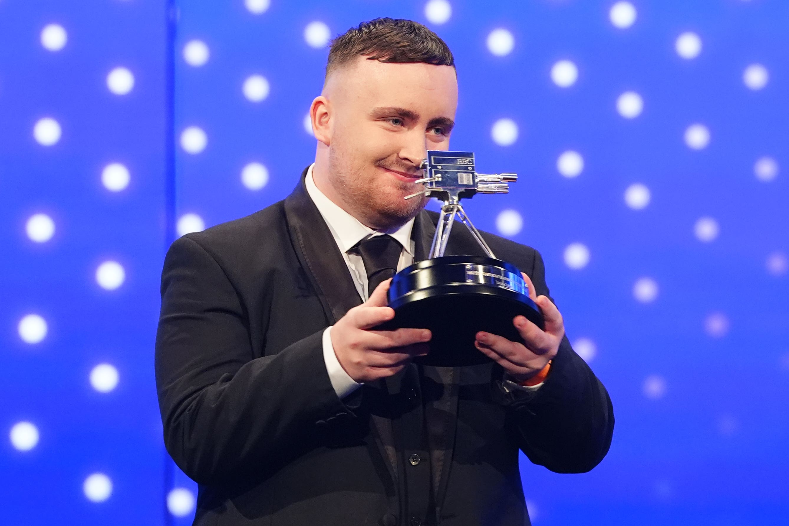 Luke Littler poses with his BBC Young Sports Personality of the Year 2024 award (David Davies/PA)