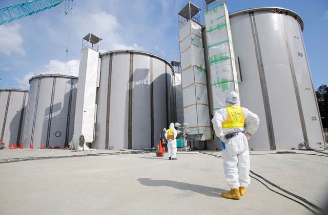 <p>A worker looks at radioactive water tanks under construction at the Fukushima Daiichi nuclear power plant in Okuma, Japan </p>