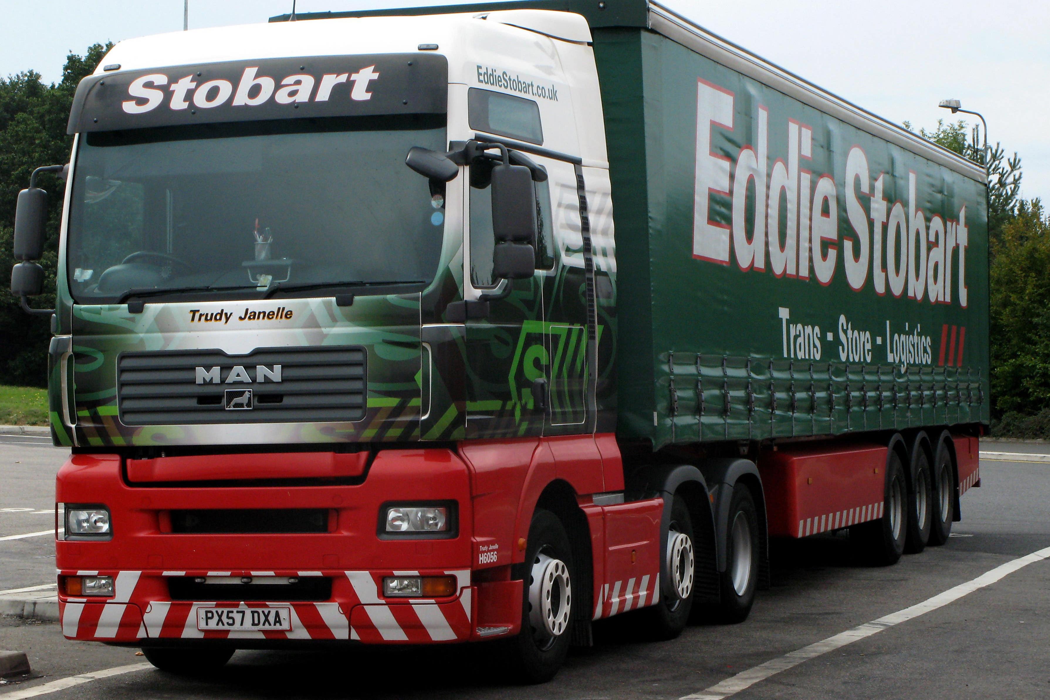 The firm is recognisable for its green and red fleet of lorries (PA)