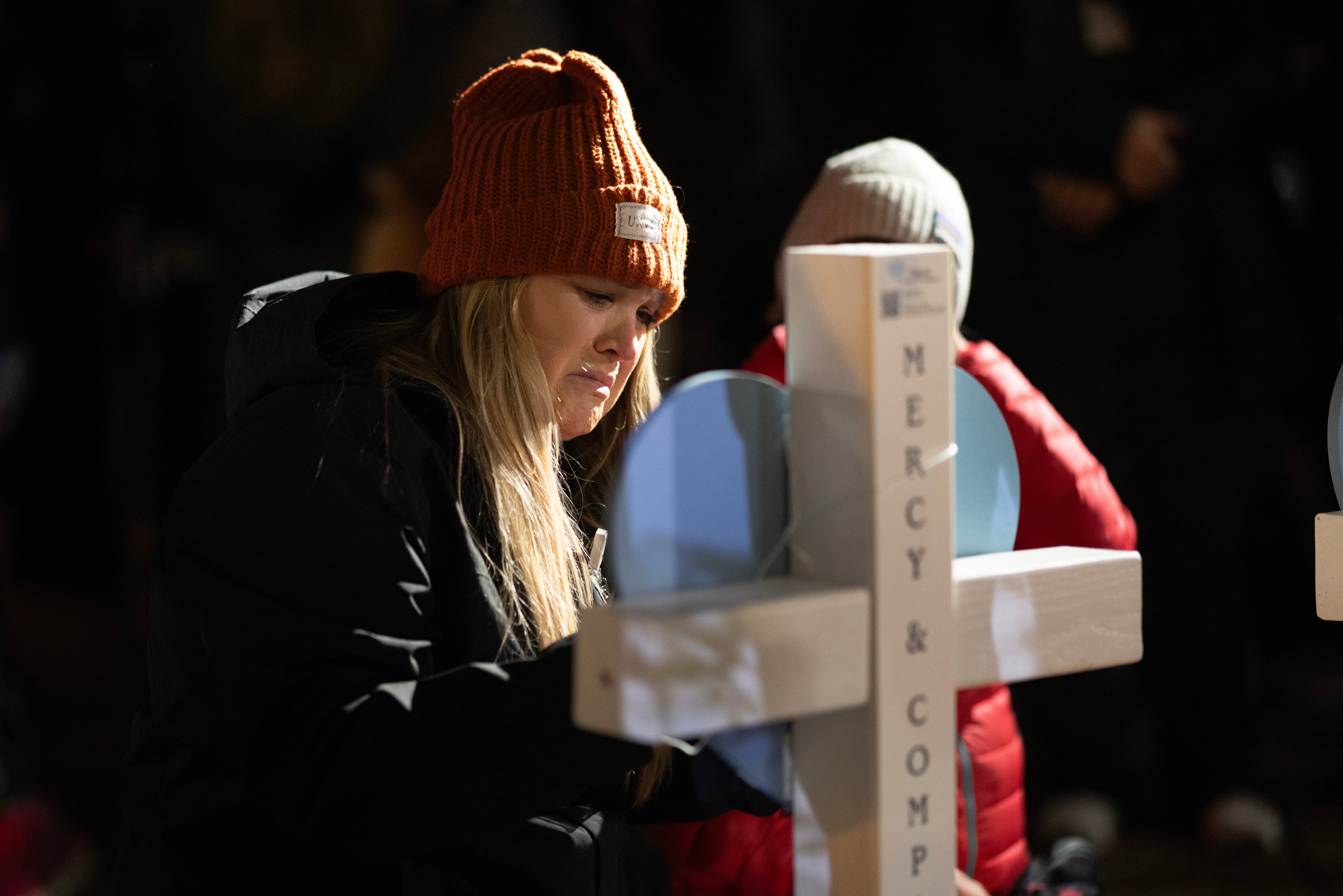 People leave messages on crosses during a vigil on the grounds of the state Capital building to mourn the victims of the shooting at Abundant Life Christian School on December 17, 2024 in Madison, Wisconsin. A 15-year-old female student opened fire at the school yesterday, killing a teacher and student and wounding six others, including two critically, before taking her own life, according to police. (Photo by Scott Olson/Getty Images)