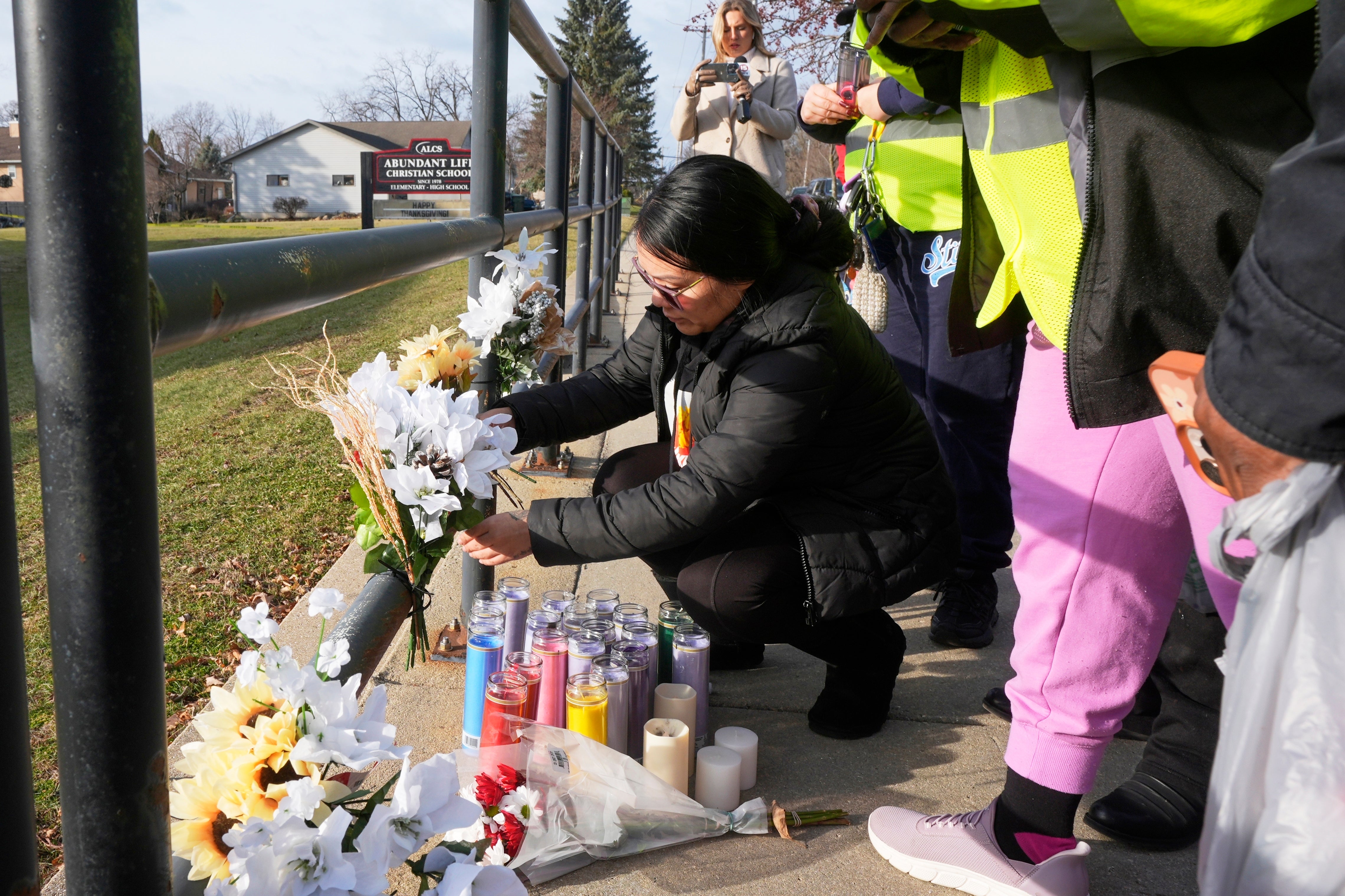 A resident places flowers at a memorial site near the site of a deadly school shooting Monday in Madison, Wisconsin.