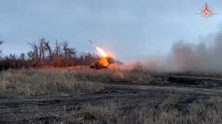 A self-propelled 122 mm multiple rocket launcher fires from Russia toward Ukrainian position at an undisclosed location