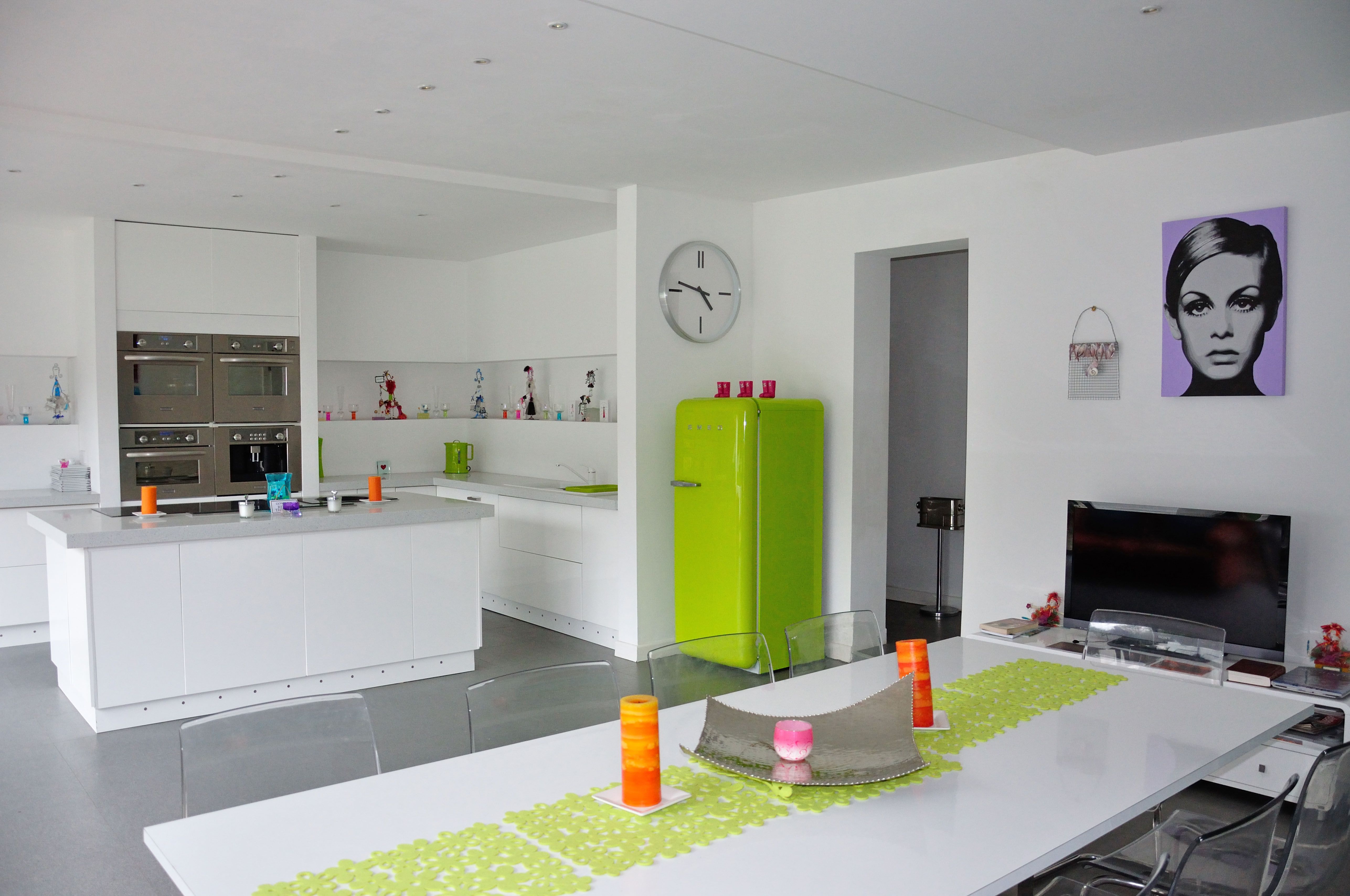 Modern open plan kitchen with colourful appliances