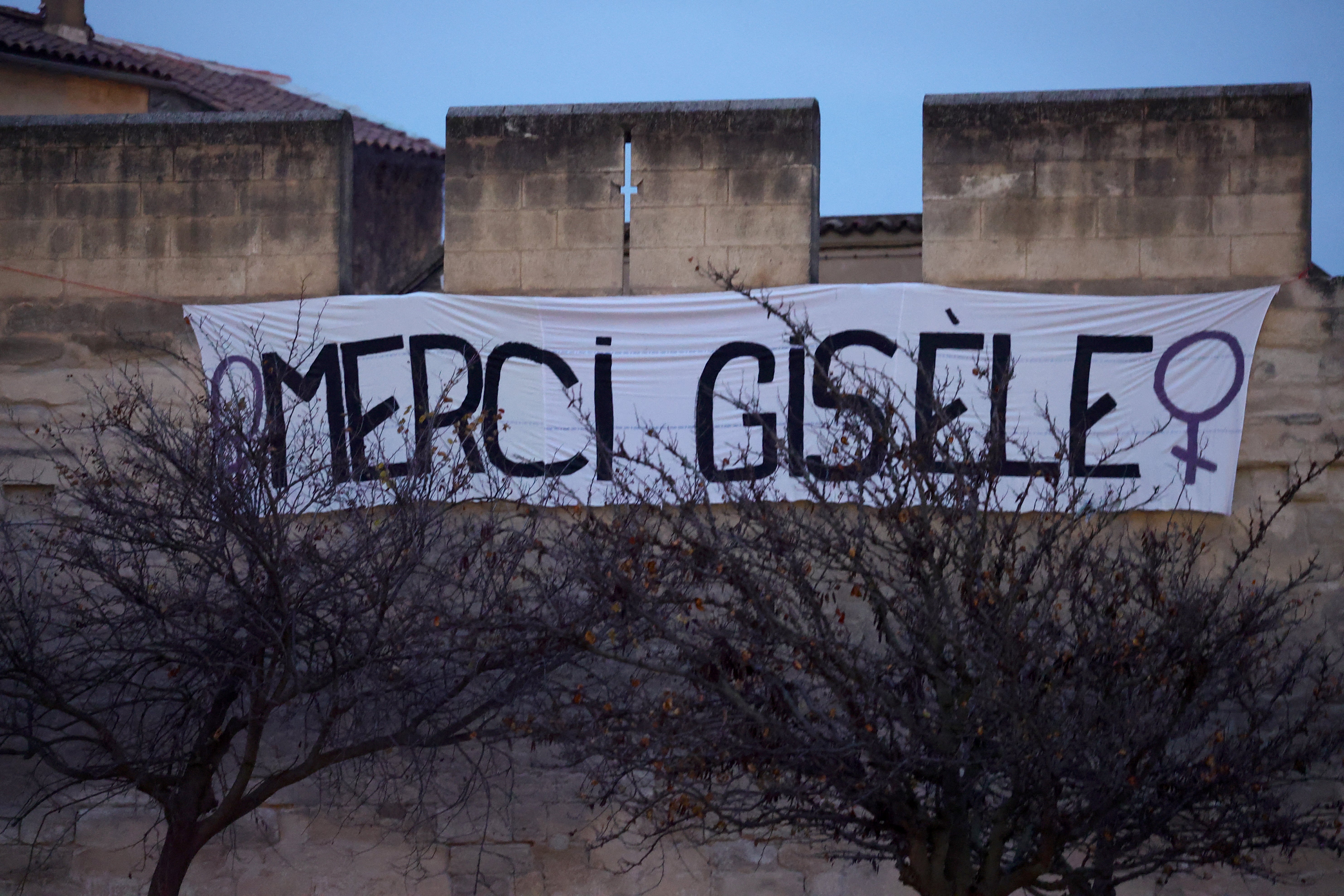 A banner reading in French “Thank you Gisele” hangs on Avignon’s old city wall on December 19