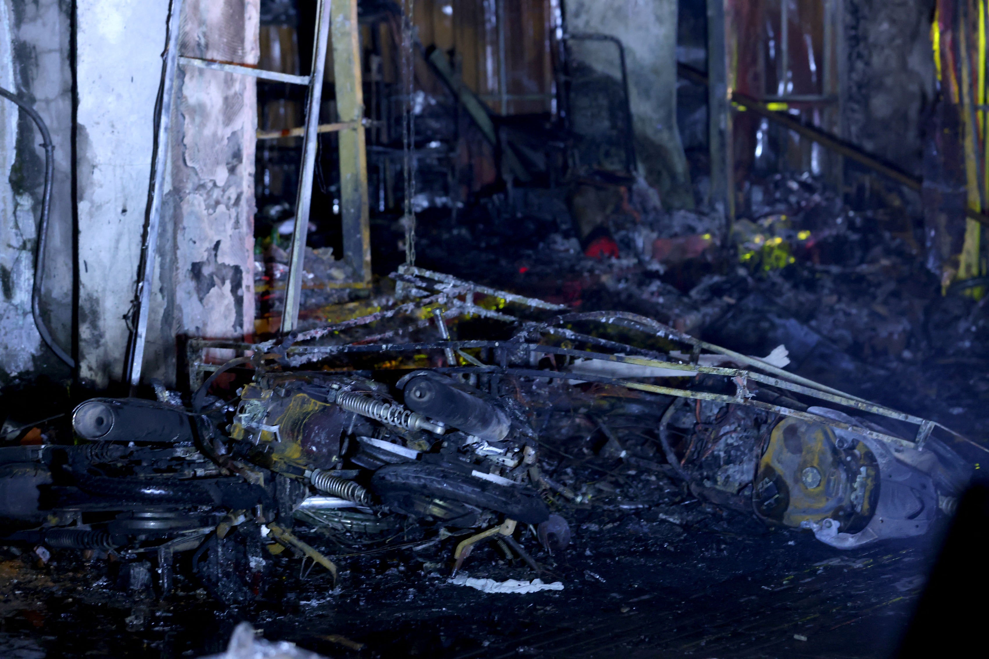 Charred belongings are seen outside a burnt house following a large fire at a karaoke bar