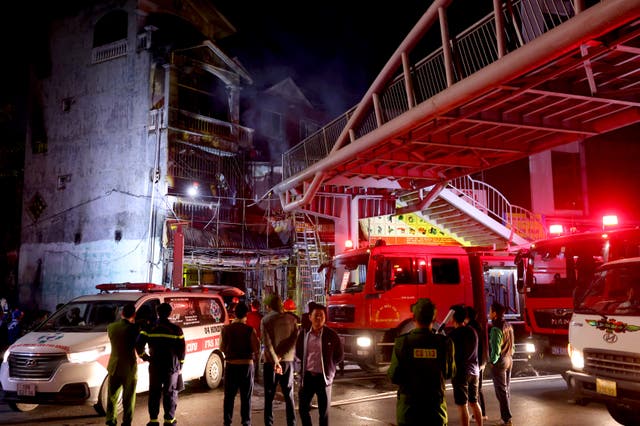 <p>Firefighters extinguish a fire at a karaoke bar in Hanoi on 19 December 2024</p>