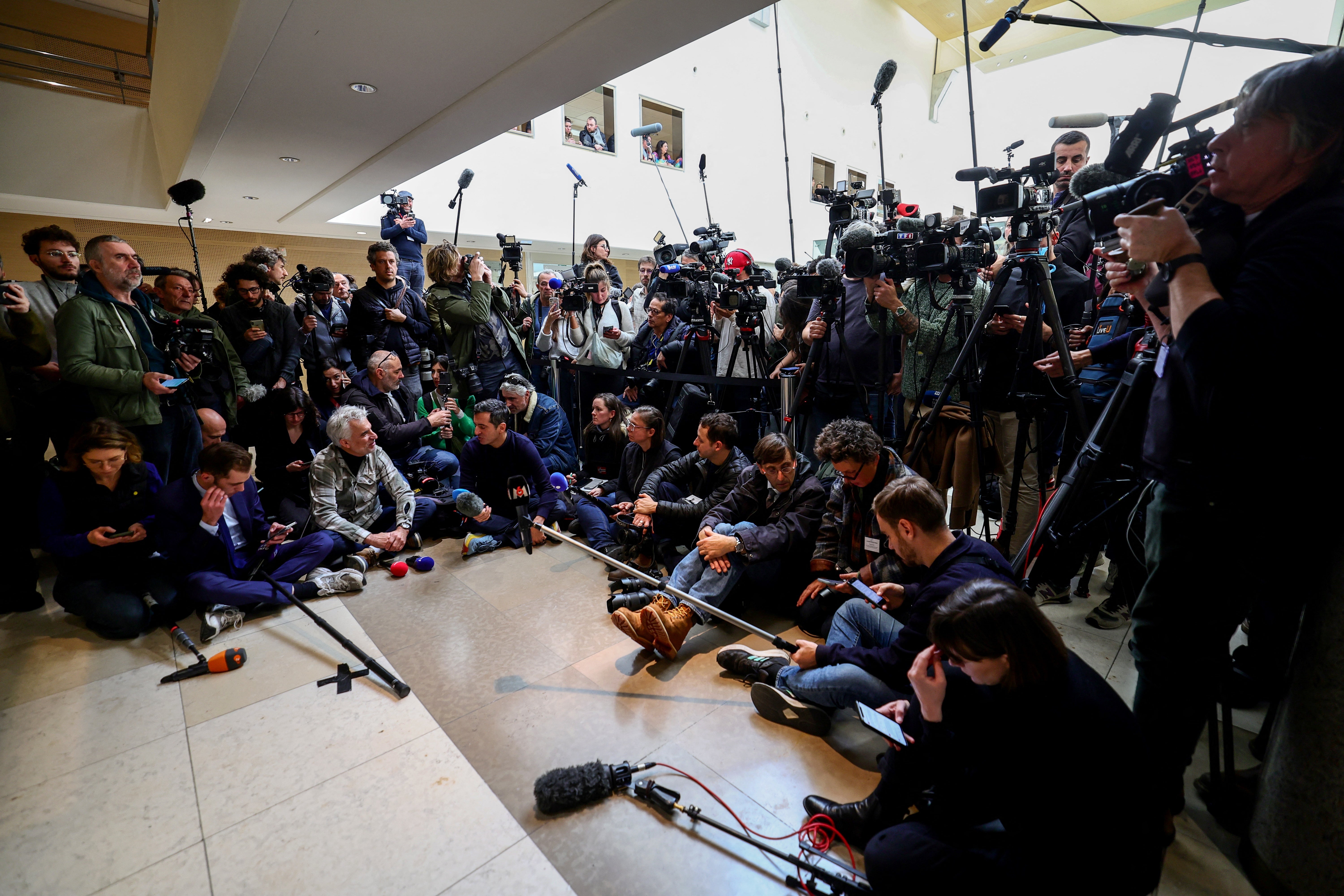 Press reporters wait for the courtroom exits in Avignon on December 19