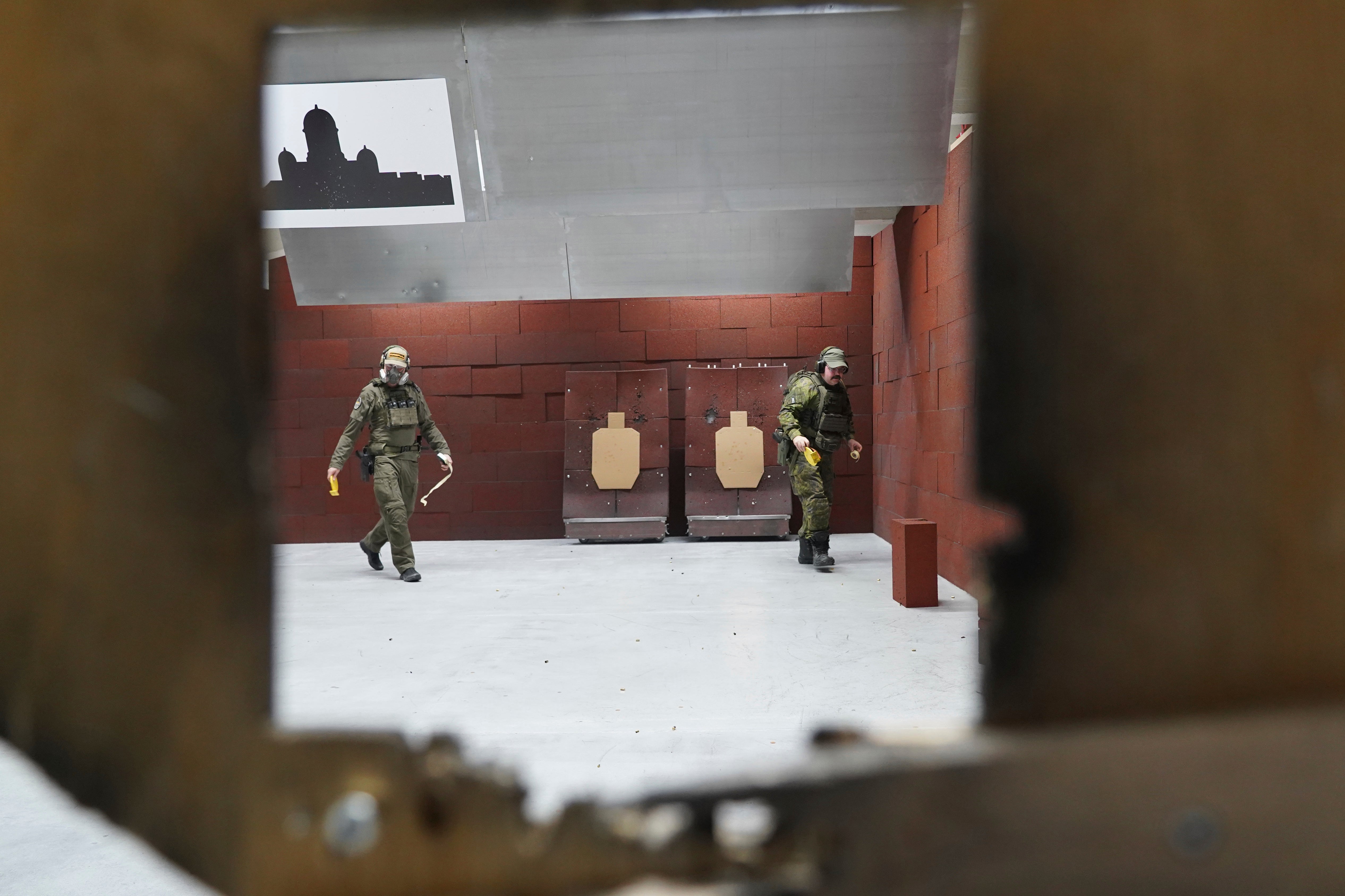 Members of the Vantaa Reservists Association practice at a shooting range in a warehouse in Kerava on the outskirts of Helsinki