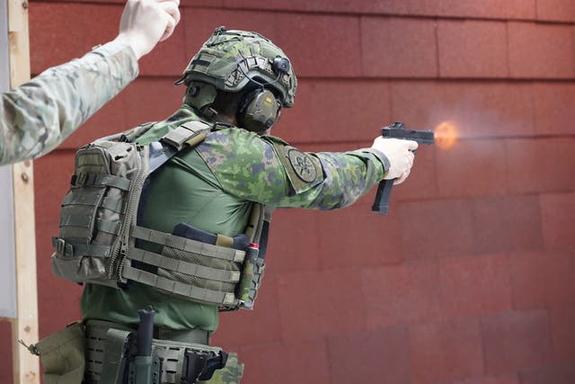 <p>Members of the Vantaa Reservists Association practice at a shooting range in a warehouse in Kerava on the outskirts of Helsinki, Finland </p>