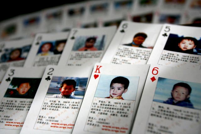 <p>File. Playing cards showing missing children are displayed in Beijing, China, in 2007 </p>