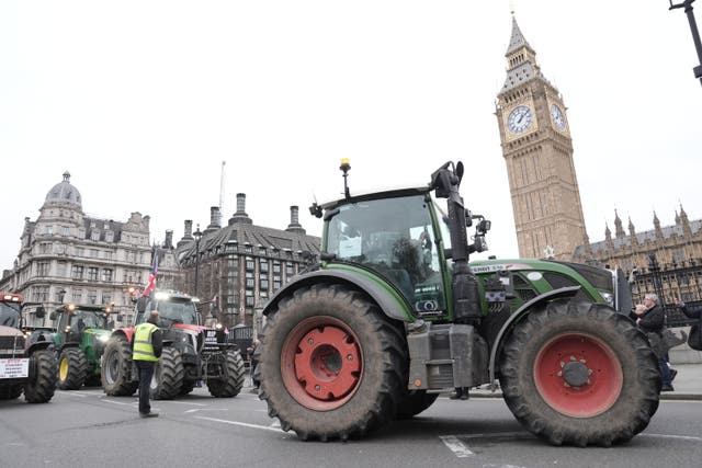 <p>Tractors line up outside the Houses of Parliament during a protest by farmers</p>