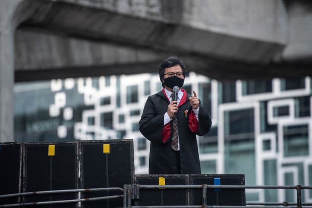 <p>Arnon Nampa, a human rights activist and a key protest leader is seen wearing wizard cloak, while giving speech during the Harry Potter-themed protest in Bangkok</p>