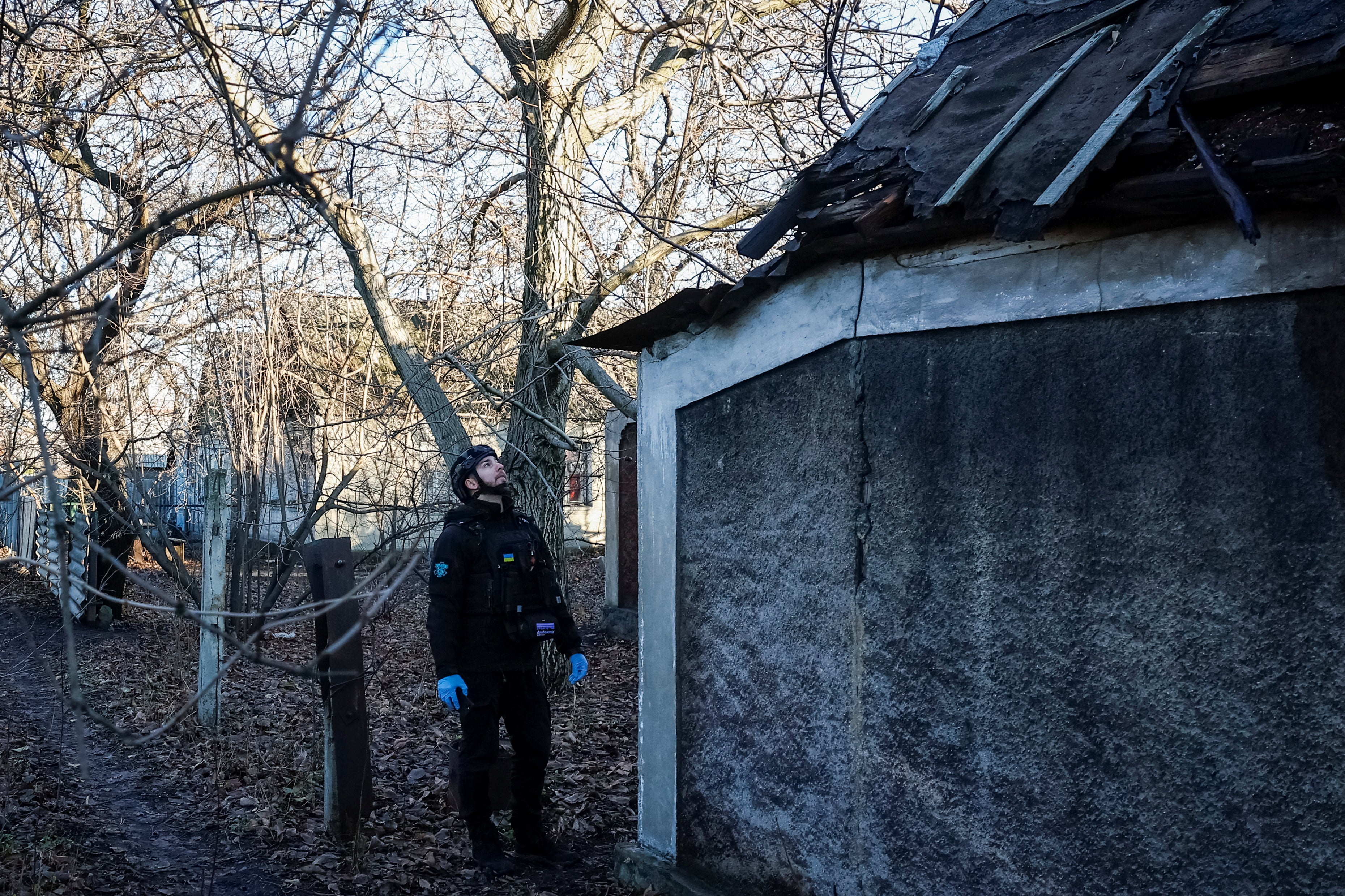 Roman Matsevko, 30, a member of the evacuation crew from East SOS Charitable Foundation, checks for military drones, amid Russia's attack on Ukraine, in the town of Pokrovsk