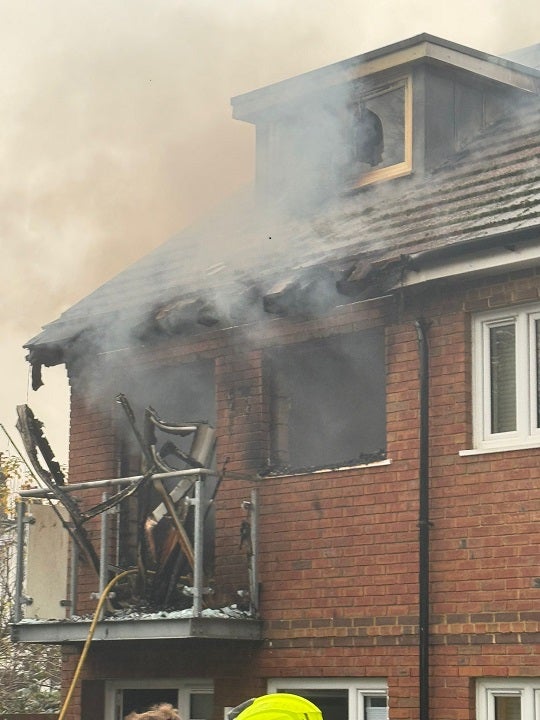 Toxic smoke pours out of the top window of the home