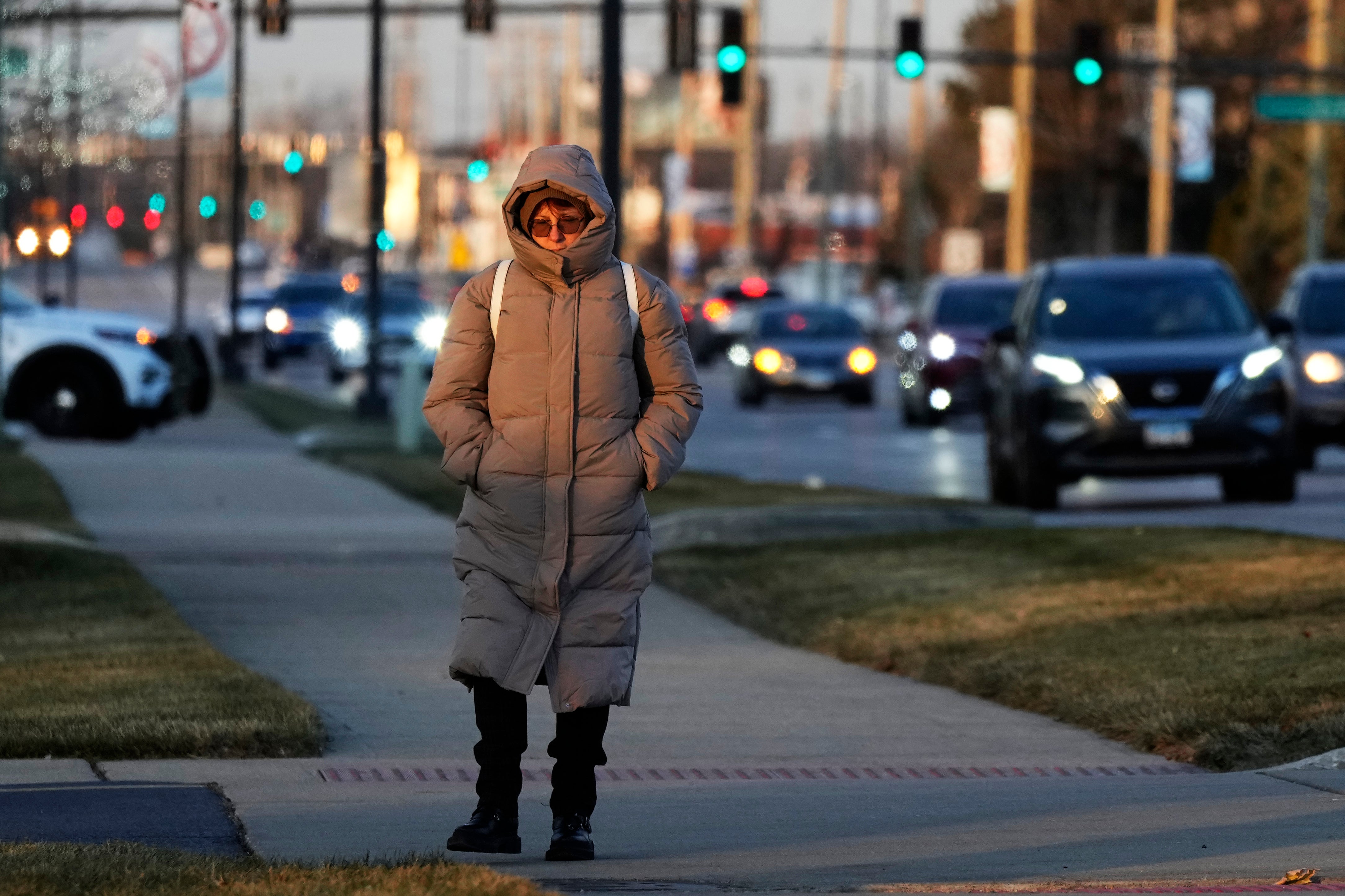 A woman bundles up as she walks on the sidewalk in Wheeling, Illinois, during a cold weather snap. New research has found that the number of cold weather-related deaths has increased since the 1990s