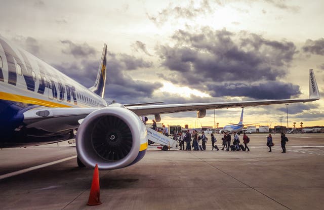 <p>Passengers boarding a Ryanair flight at Edinburgh Airport</p>