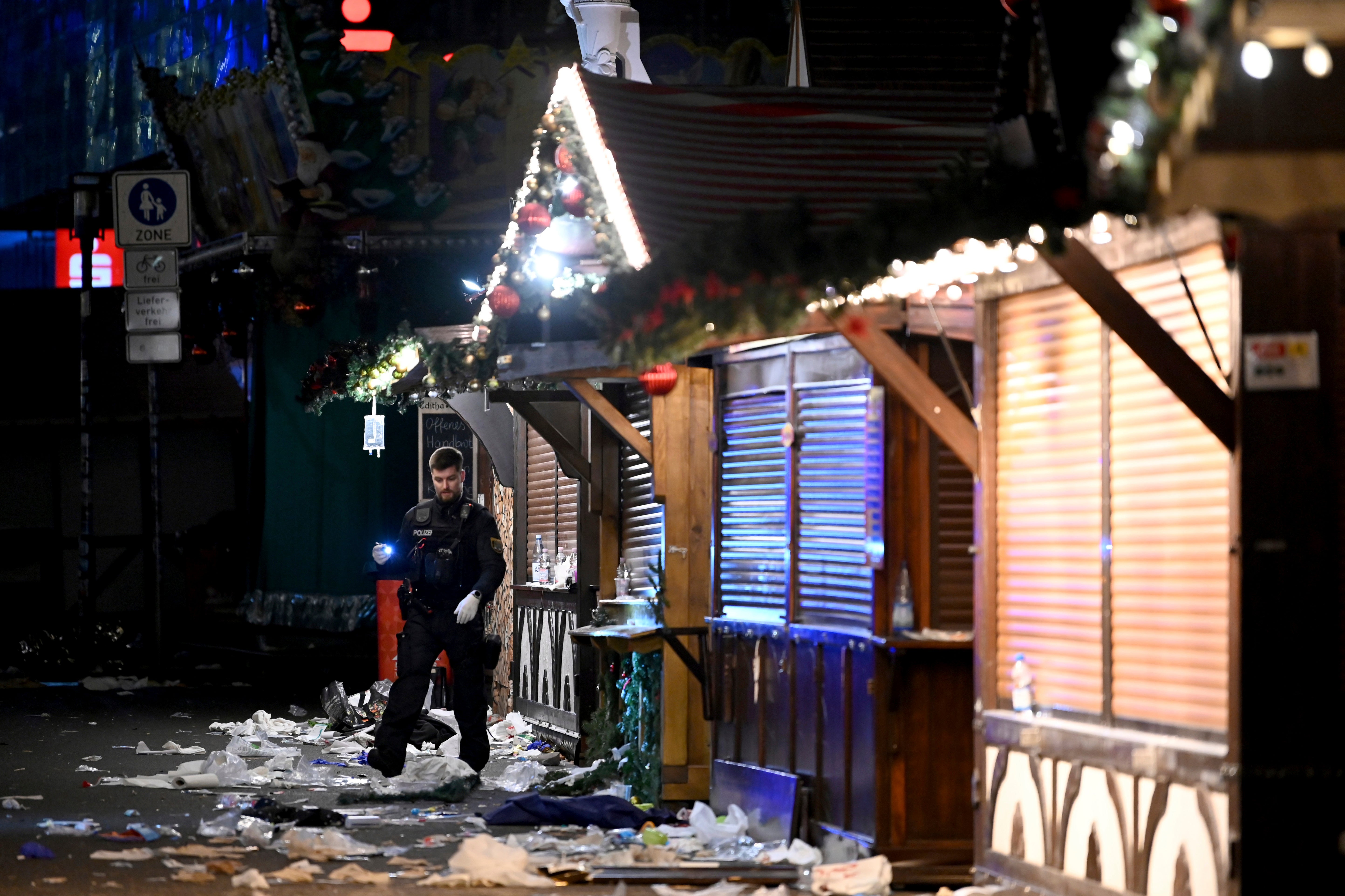 A policeman is seen at the Christmas market where an incident happened in Magdeburg