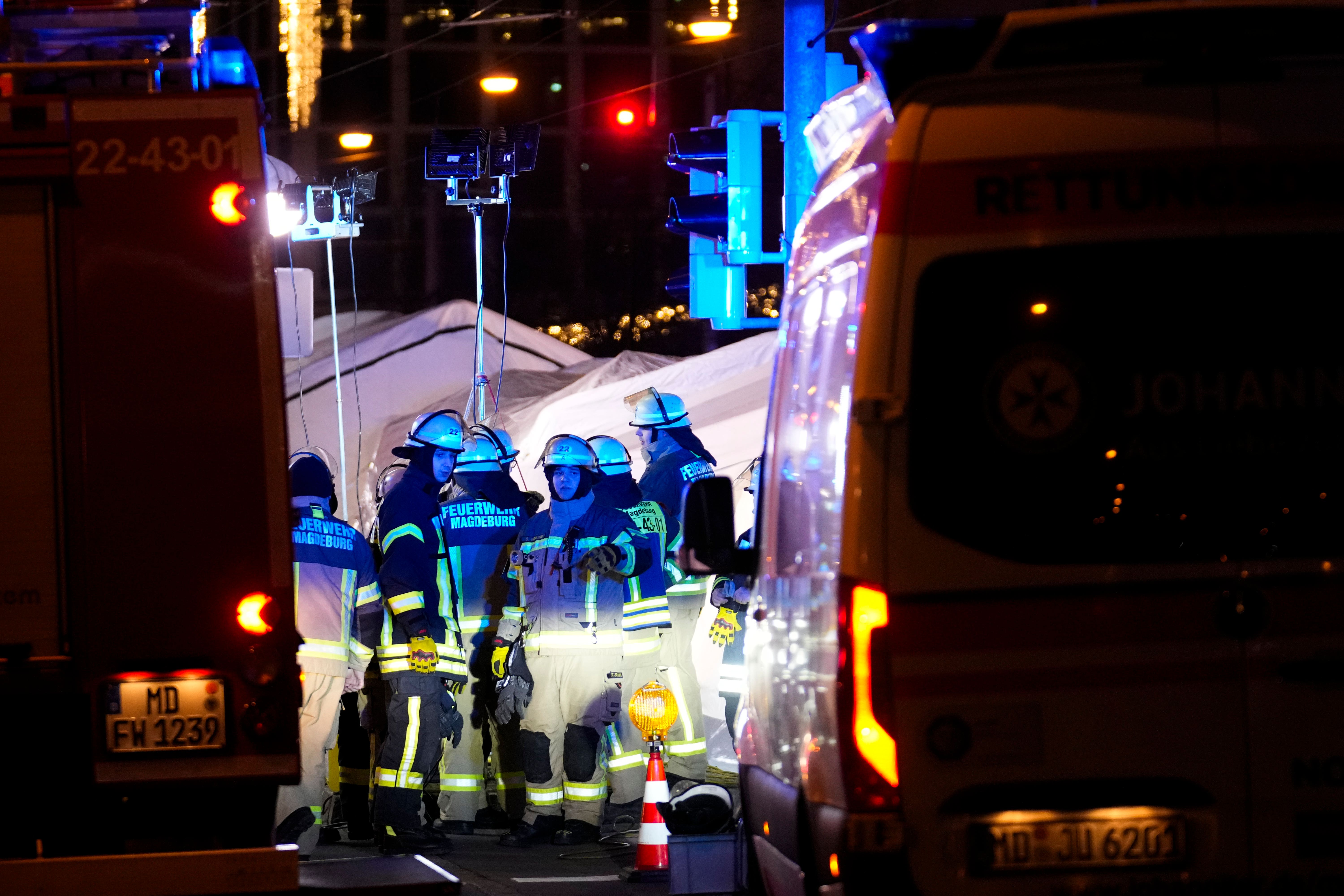 Emergency services work in a cordoned-off area near a Christmas Market after a car drove into a crowd in Magdeburg, Germany (Ebrahim Noroozi/AP)