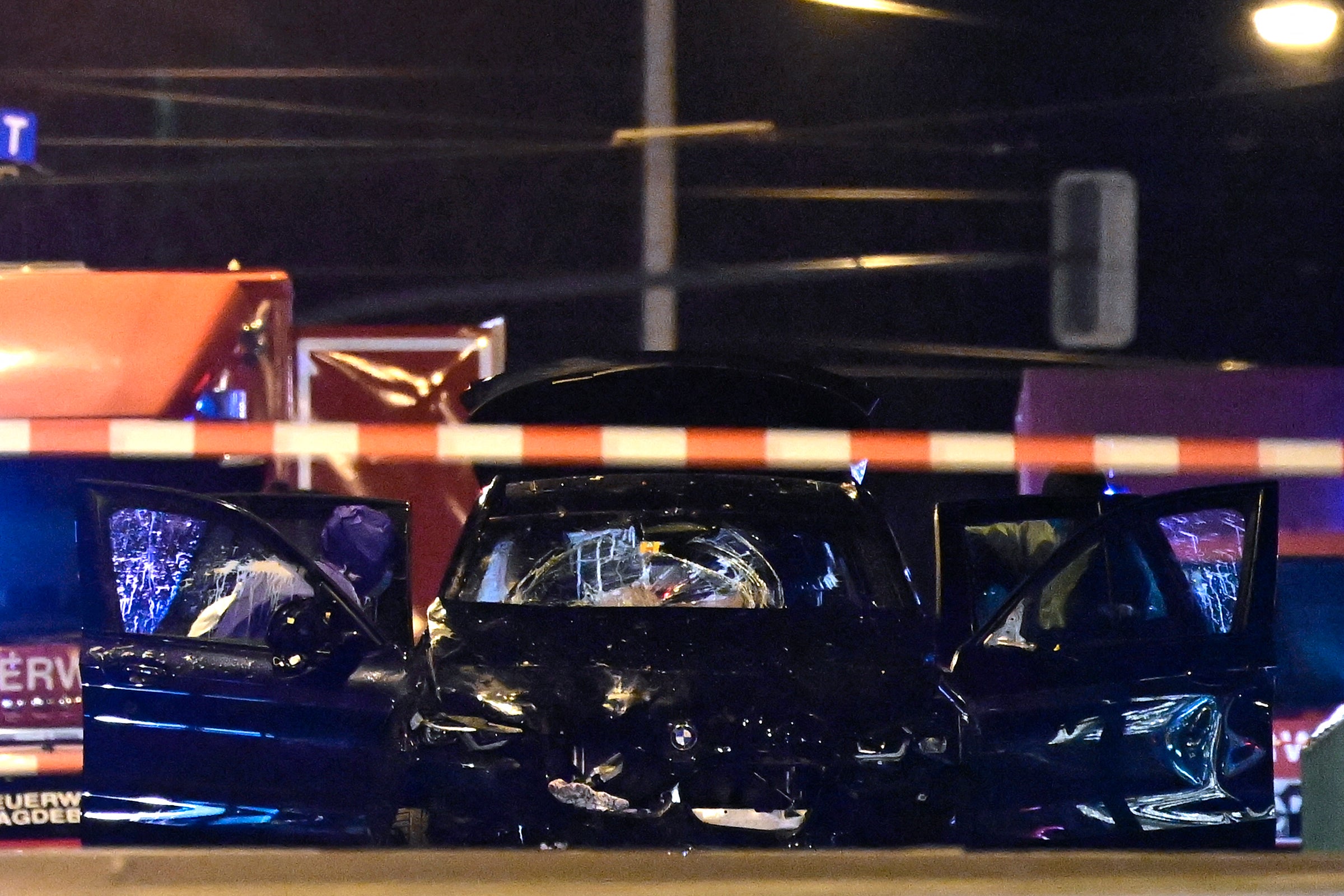 The black smashed up BMW pictured at the scene following the attack