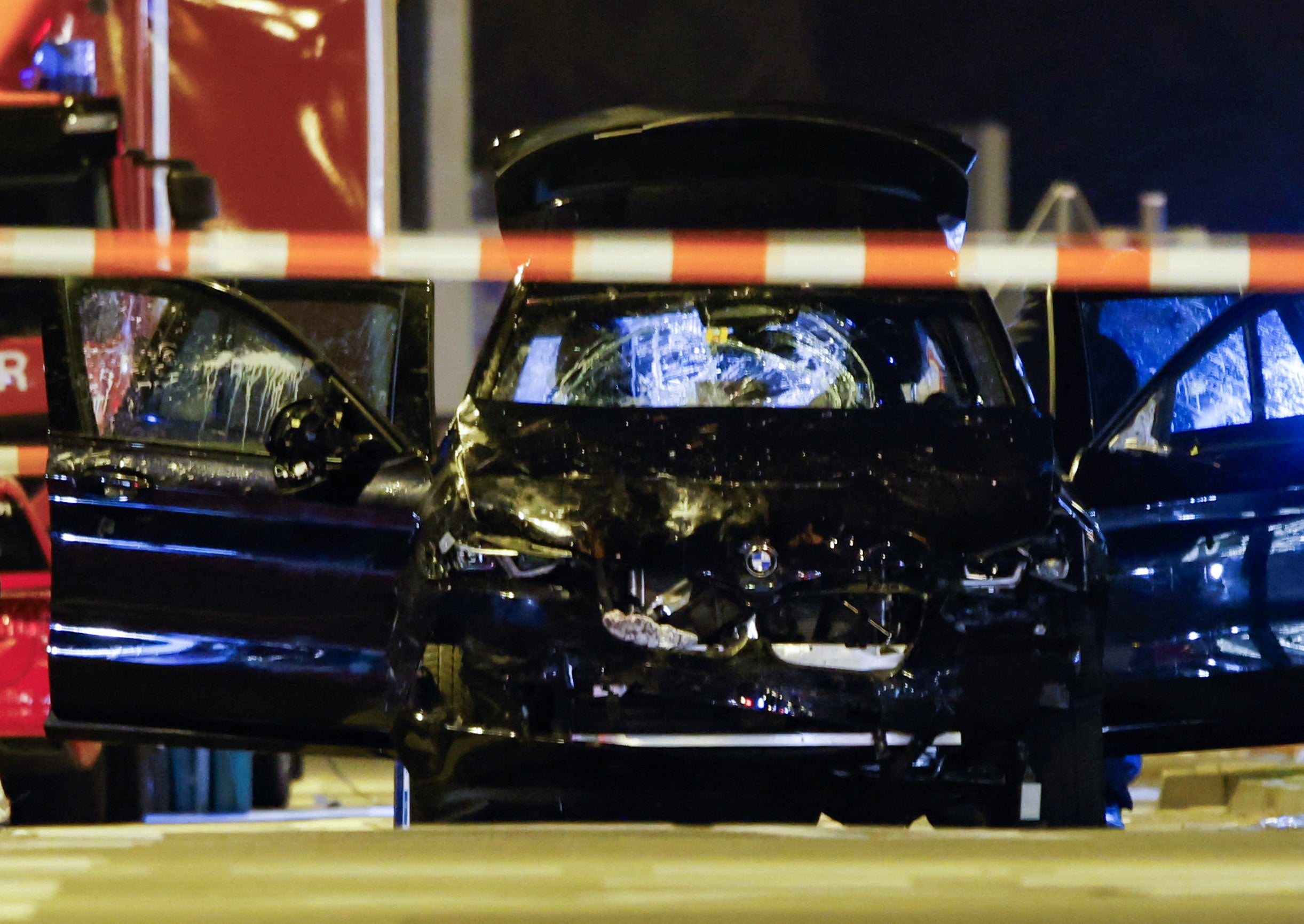 The suspect’s smashed up car pictured behind a police cordon