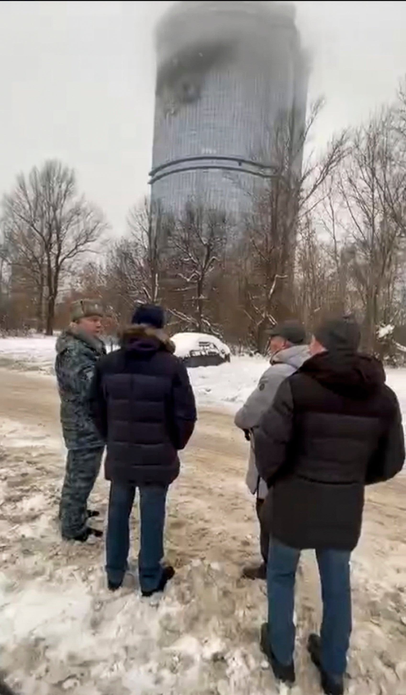 Local officials look at a damage site at the residential complex in Kazan, Russia, following Ukrainian drone attacks