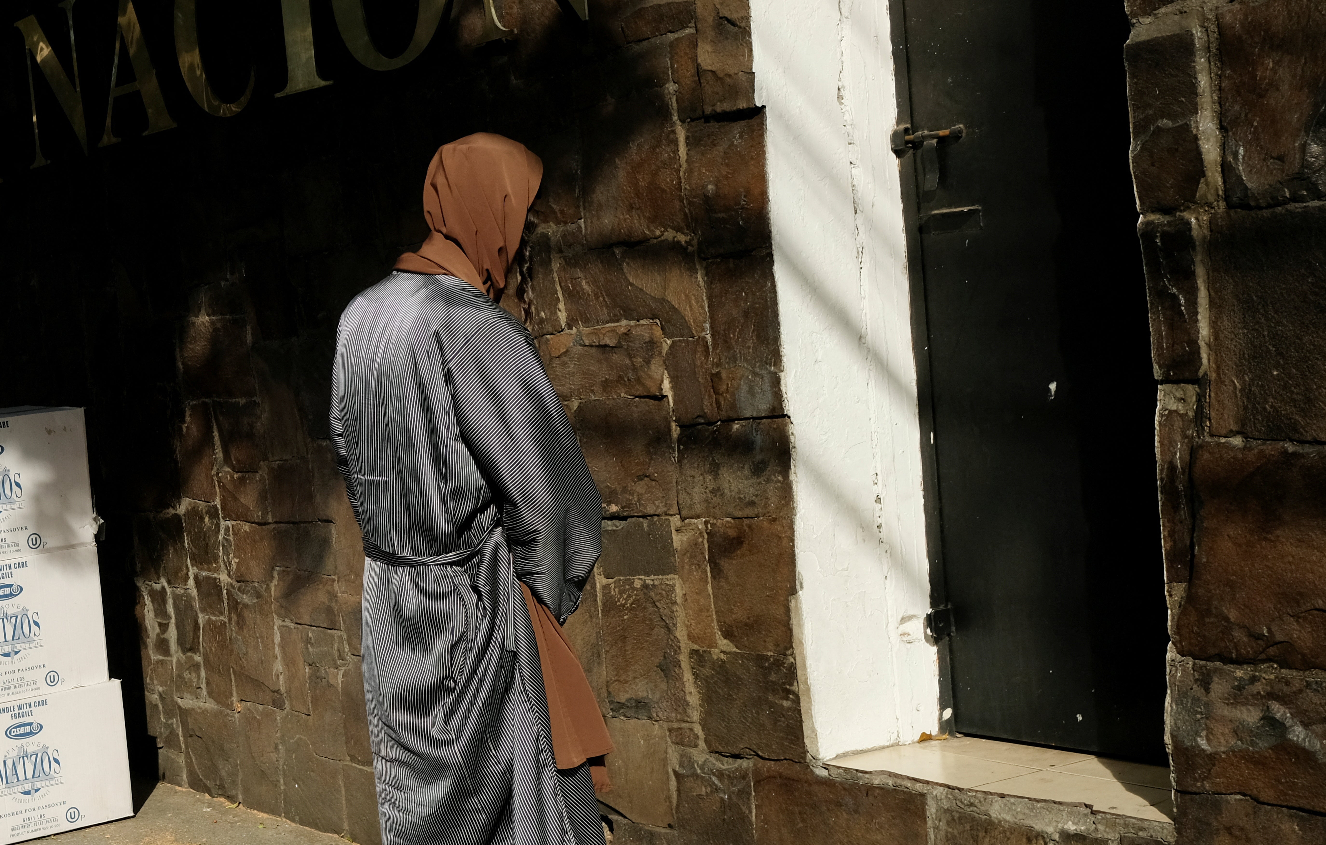 A Lev Tahor member waits outside the Guatemala Attorney General’s Office after authorities rescued over 100 children and adolescents from the Jewish community following allegations of child abuse