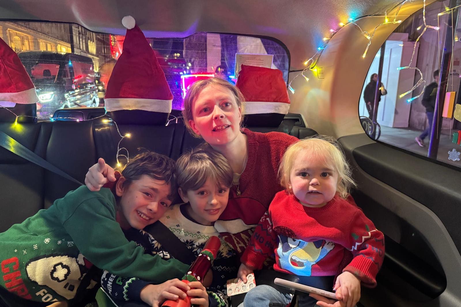 Alfie, with mum Kathleen and older brothers Teddie (far left) and Bobby, was treated to a black cab tour of central London’s festive lights (Handout/PA)