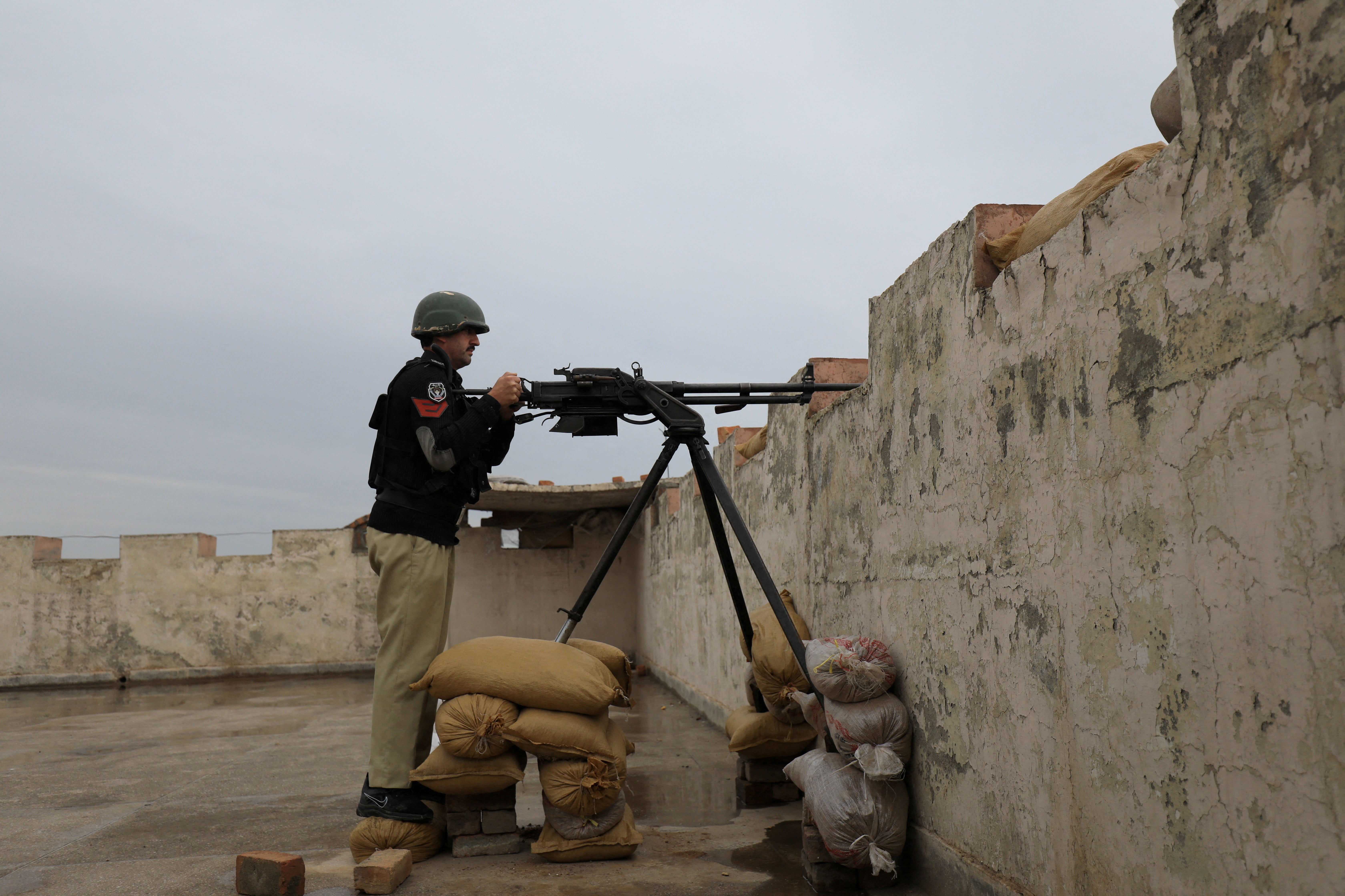 File. Police officer takes position at the Sarband police station on the outskirts of Peshawar, Pakistan, on 9 February 2023