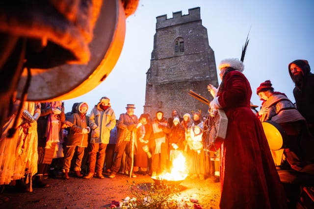 People take part in the winter solstice celebrations during sunrise at Glastonbury Tor in Somerset (James Manning/PA)