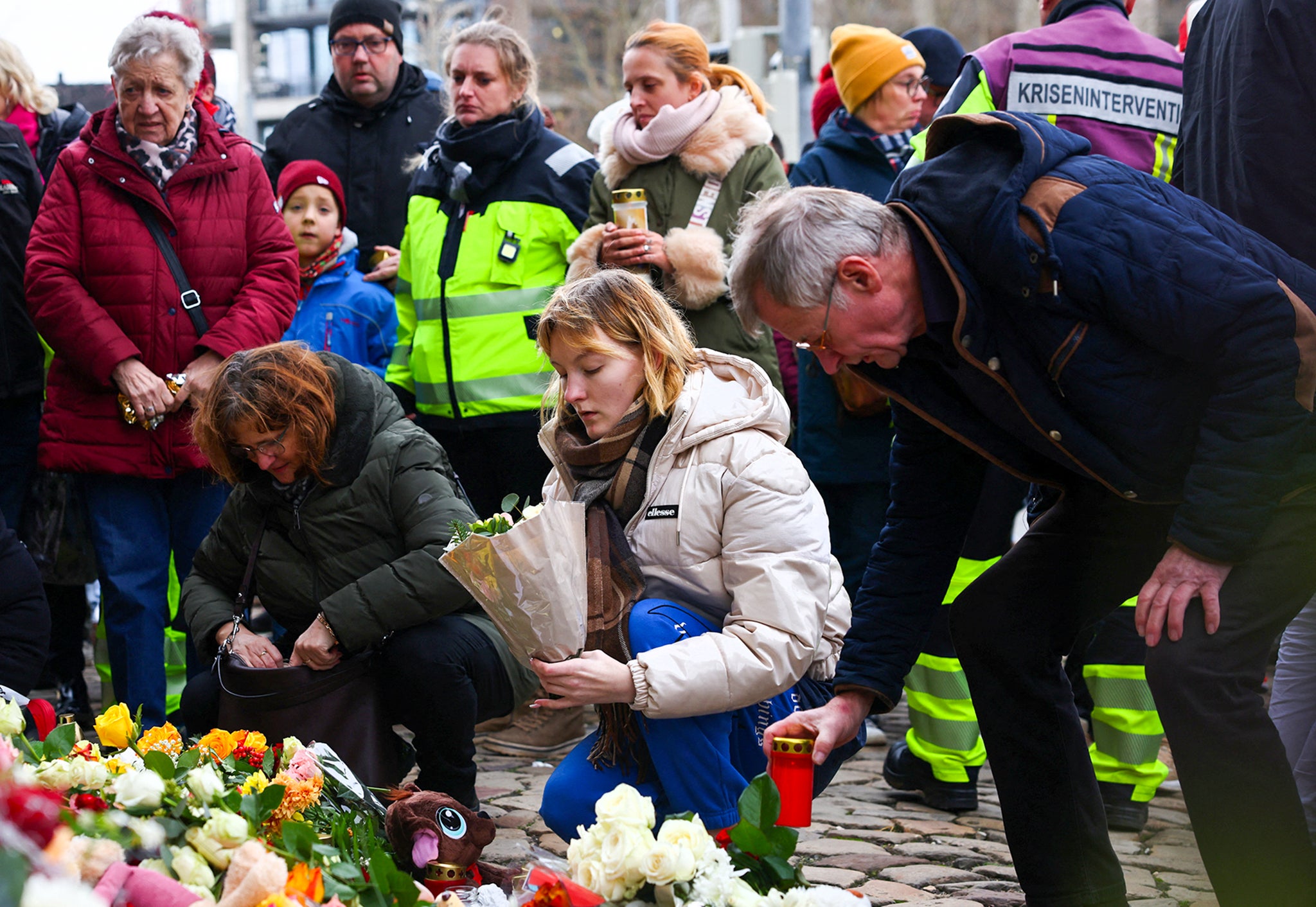 Tributes piled up as state leaders visited the site of the attack where a driver ploughed a car into crowds at around 7pm on Friday