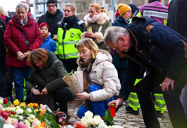 <p>Tributes piled up as state leaders visited the site of the attack where a driver ploughed a car into crowds at around 7pm on Friday</p>