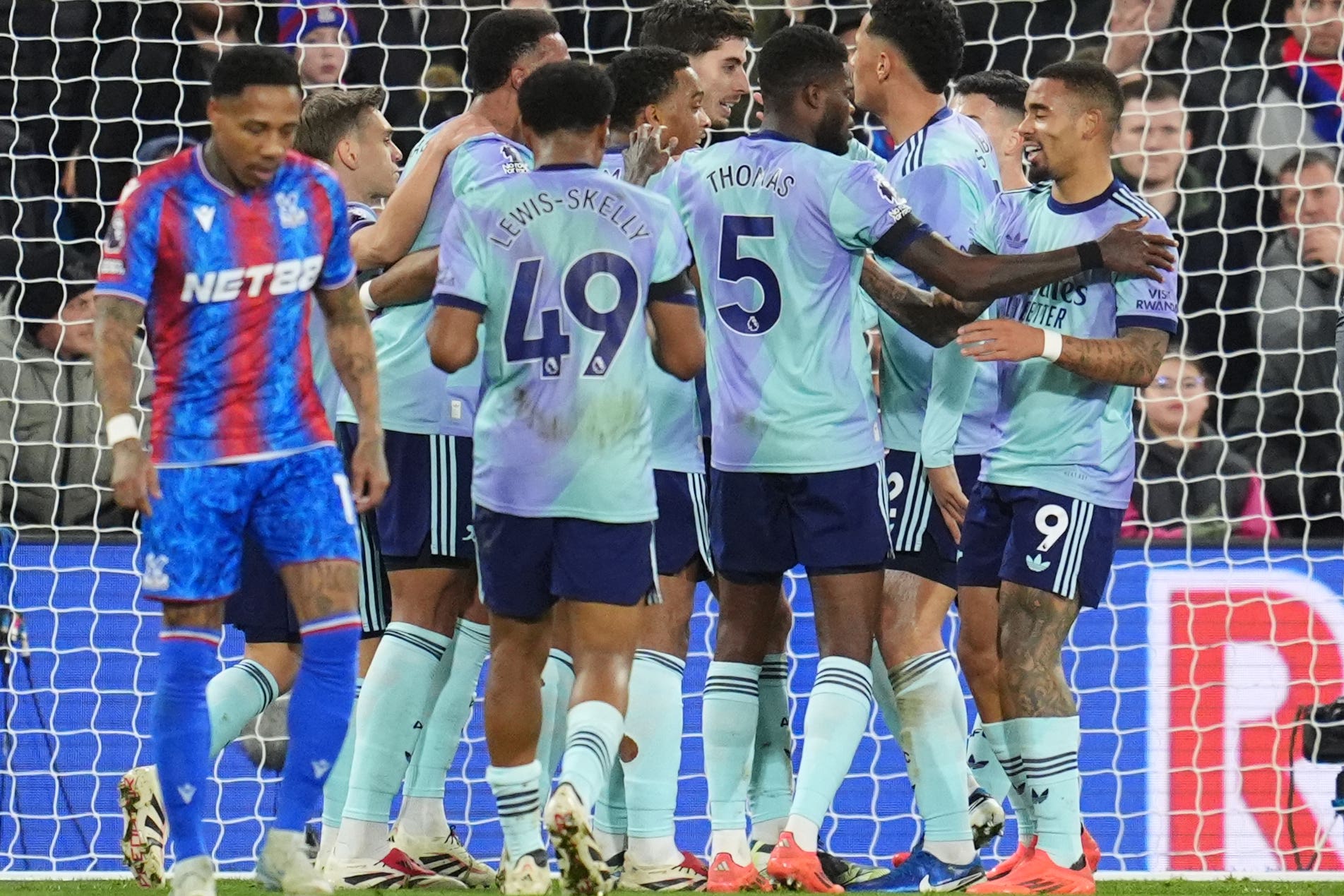 Arsenal players celebrate one of their five goals with a group hug