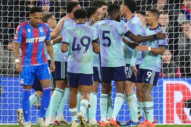 <p>Arsenal players celebrate one of their five goals with a group hug</p>