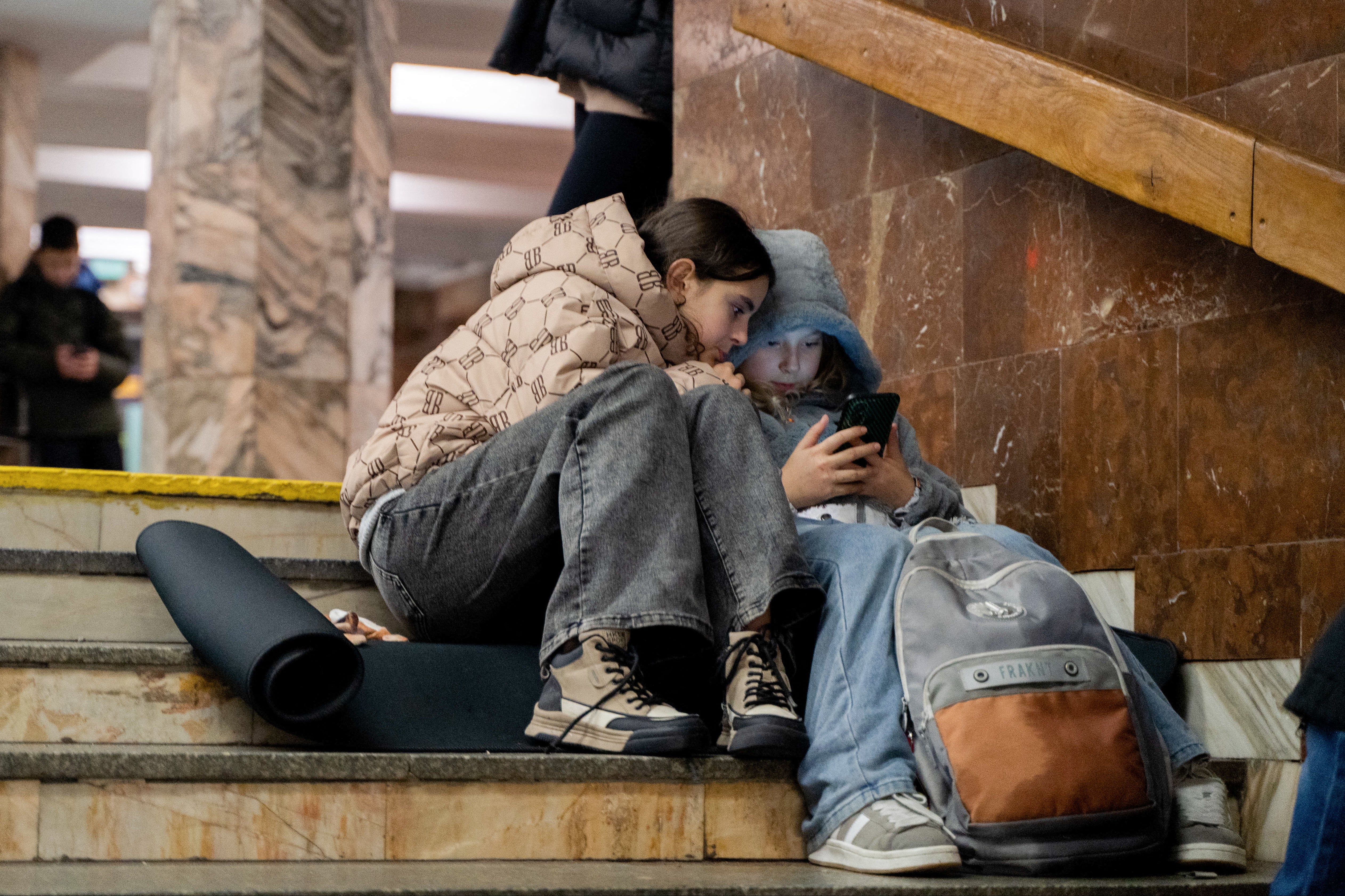 Children take shelter in a metro station during an air strike alarm in Kyiv