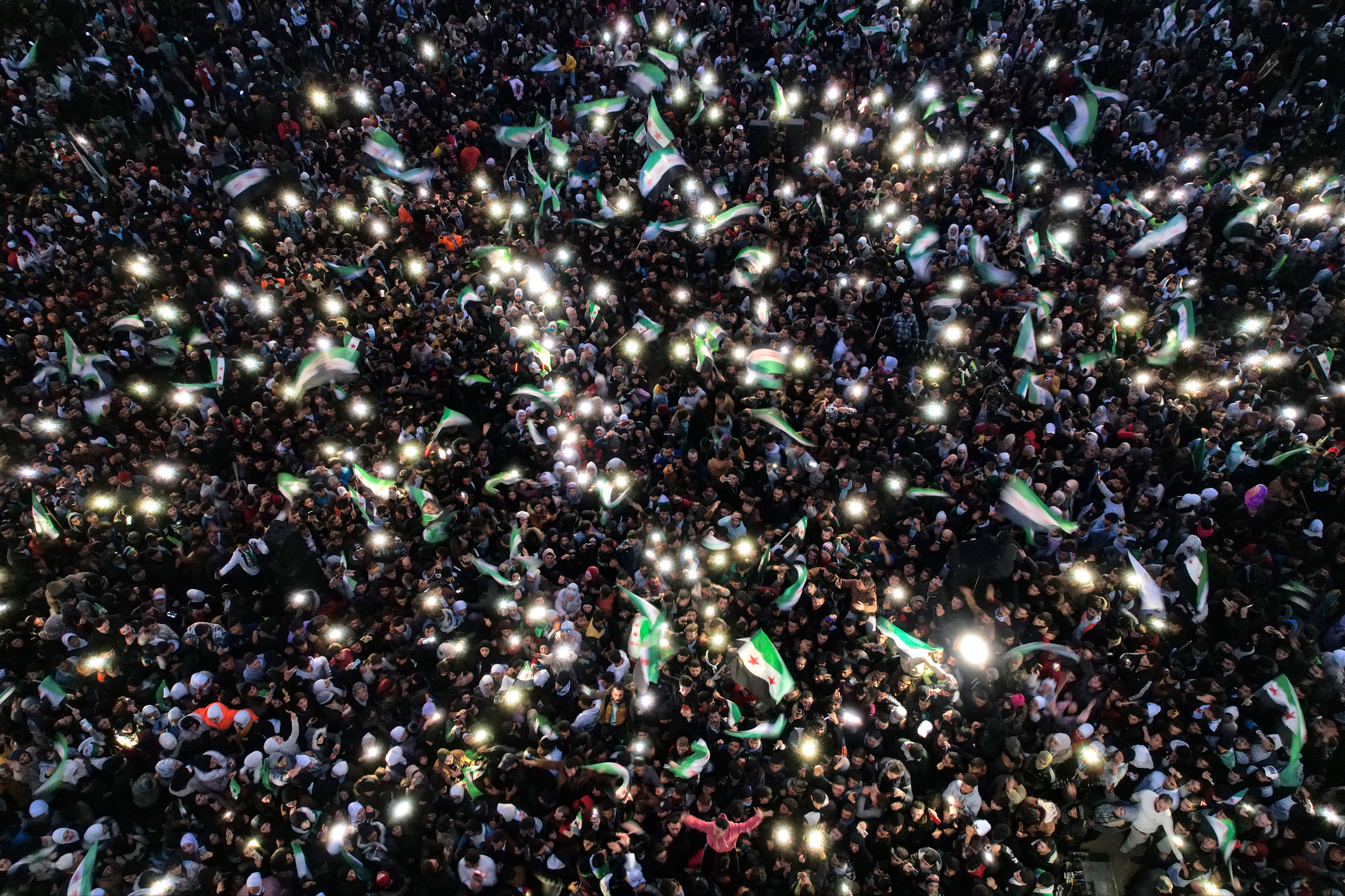 People gather at Aleppo’s Saadallah al-Jabri Square as they take part in rallies celebrating the fall of Syria’s president Bashar al-Assad