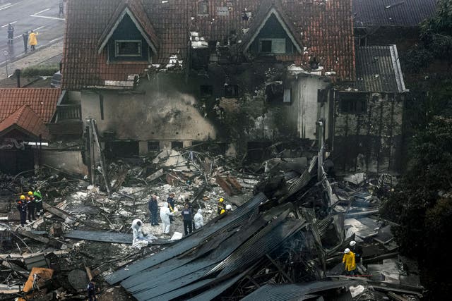 <p>Firefighters and other rescue teams work in the site of a plane crash at the city of Gramado, Rio Grande do Sul state, Brazil, on 22 December 2024</p>