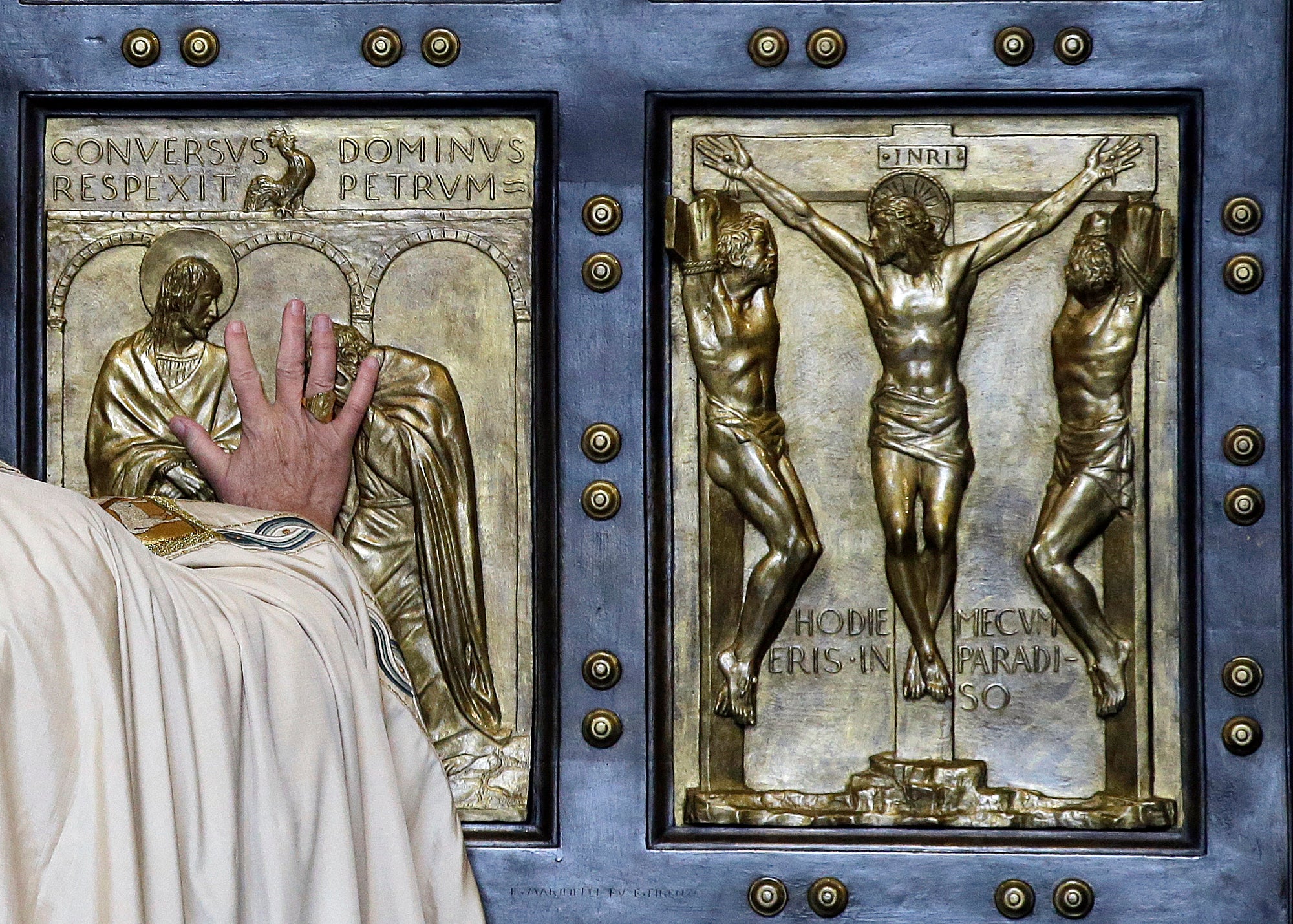 Pope Francis pushes open the Holy Door of St. Peter’s Basilica, formally launching the Holy Year of Mercy